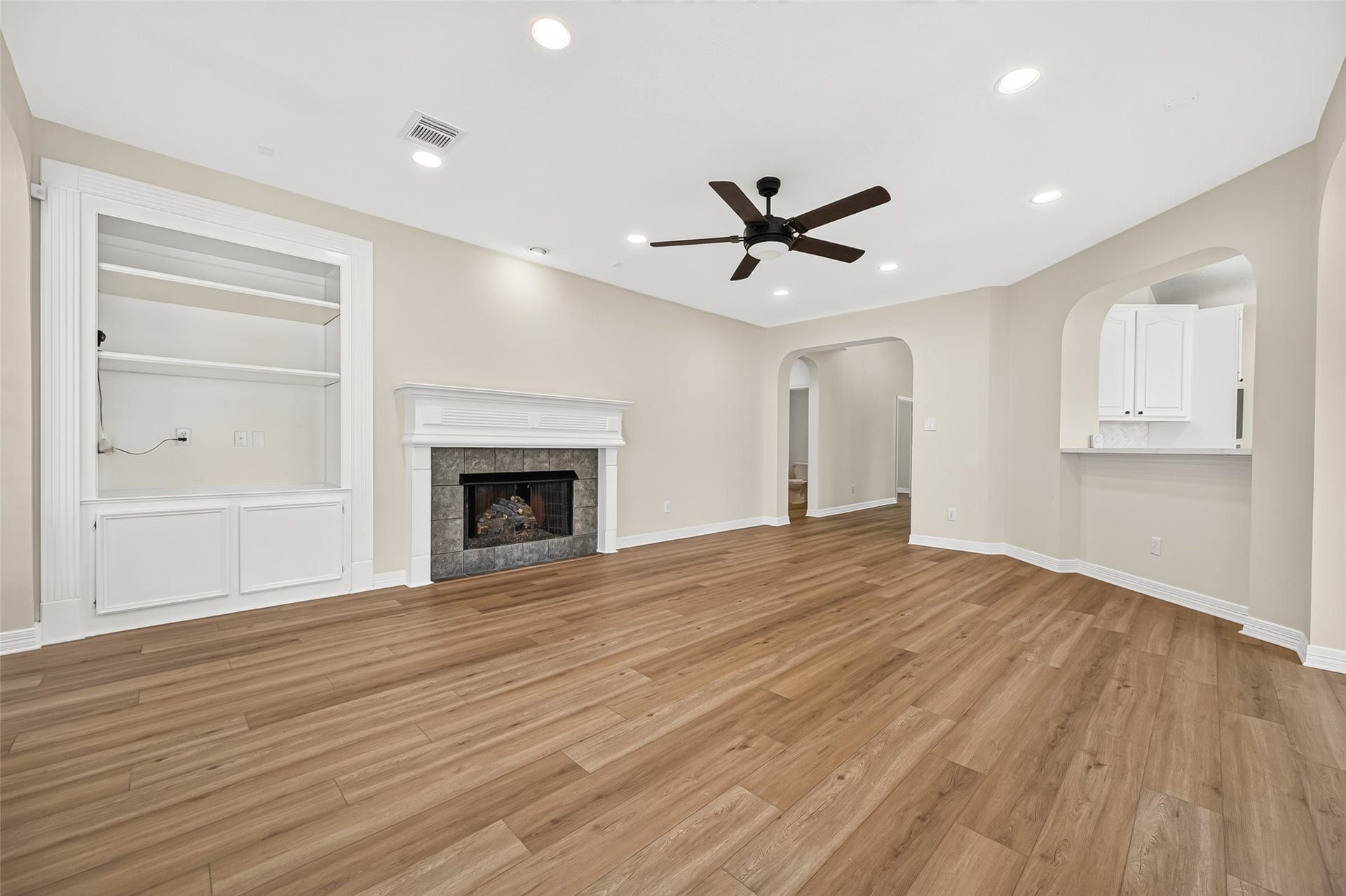 826 Ivory Ridge Lane, Houston, TX 77094 COZY UP BY THE FIRE! A gas-log fireplace creates a warm focal point in the family room, framed by a classic mantel & tiled surround. Its easy to envision stockings hanging from the mantel during the holidays. Built-in cabinetry & open shelving provide space for books, photos, treasured keepsakes, or seasonal dcor. Surround-sound speakers are built into the ceiling, with wiring conveniently housed inside the cabinetry. Generous wall space offers plenty of flexibility for arranging furniture.