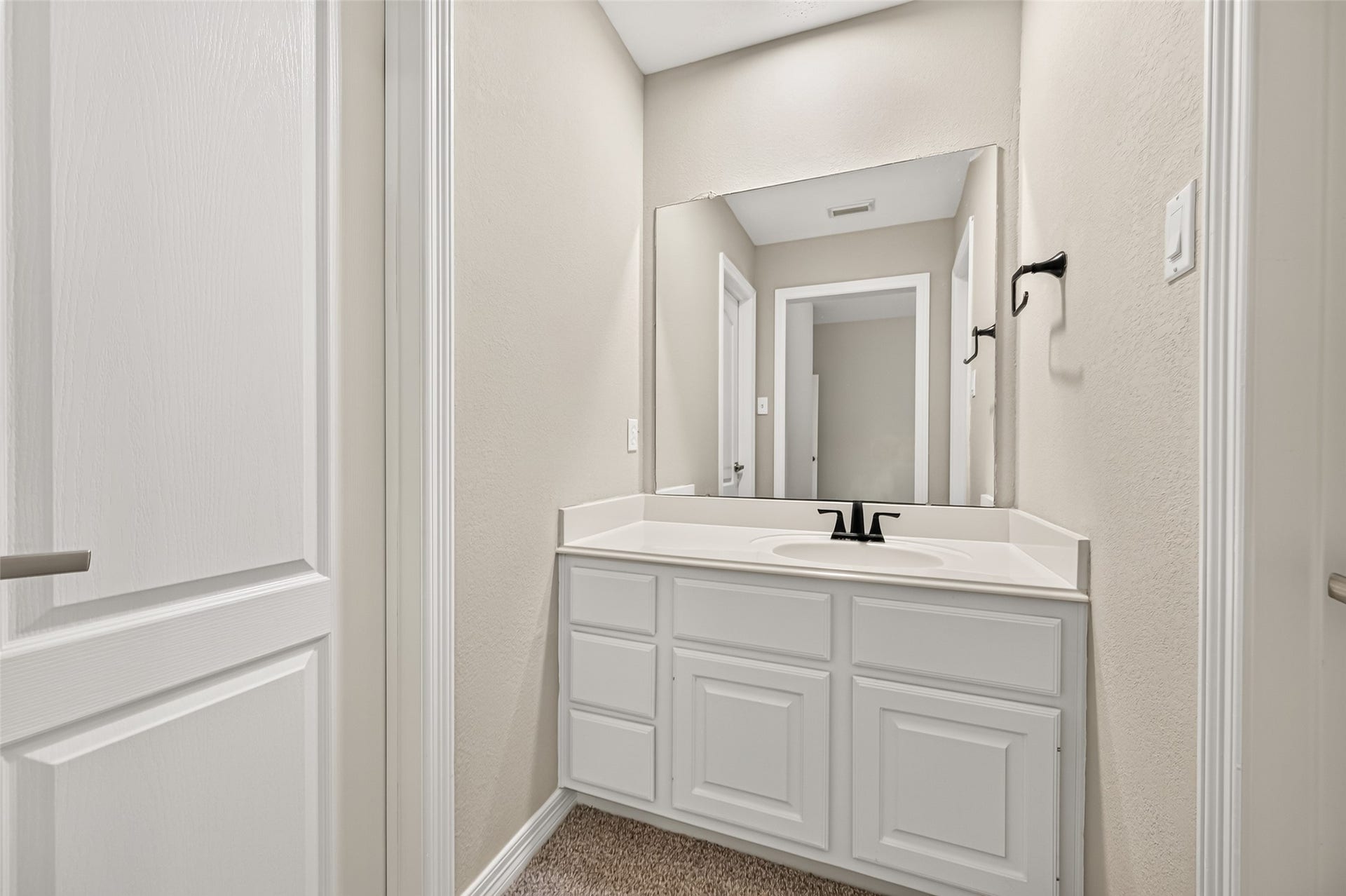 826 Ivory Ridge Lane, Houston, TX 77094 YOUR OWN SPACE! Bedroom #2 features its own private sink vanity, providing dedicated space for getting ready along with cabinet & counter storage. To the right, a large lighted walk-in closet offers generous wardrobe space. To the left is the shared portion of the Jack & Jill bath connecting Bedrooms #2 & #3.