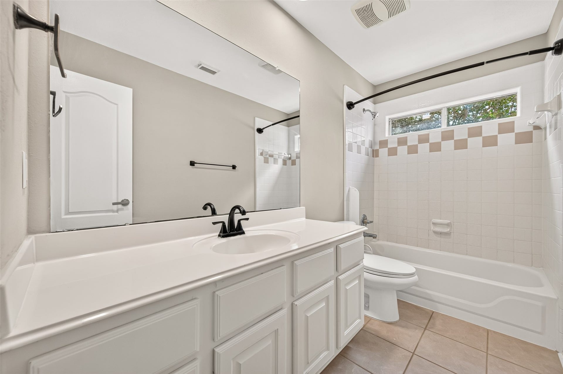 826 Ivory Ridge Lane, Houston, TX 77094 A 3RD FULL BATH UPSTAIRS! Conveniently located near Bedroom #4 & the Gameroom, Bath #3 features a long vanity with generous counter & cabinet space, large wall mirror, tub/shower combination & tile flooring. A wide transom-style window above the tub brings in natural light while maintaining privacy.