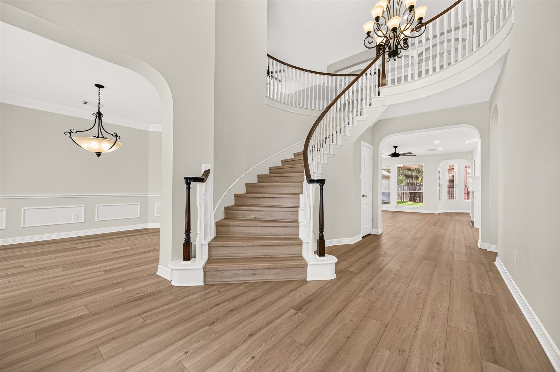 826 Ivory Ridge Lane, Houston, TX 77094 WHAT AN ENTRANCE! The elegant sweeping staircase takes center stage in the soaring 2-story foyer, creating a beautiful architectural focal point from the moment you enter. Rich wood handrails & newel posts contrast beautifully with crisp white spindles, while LVP flooring continues seamlessly up the staircase. From here, the home opens naturally with the formal dining room to the left, study to the right, and a spacious family room beyond.
