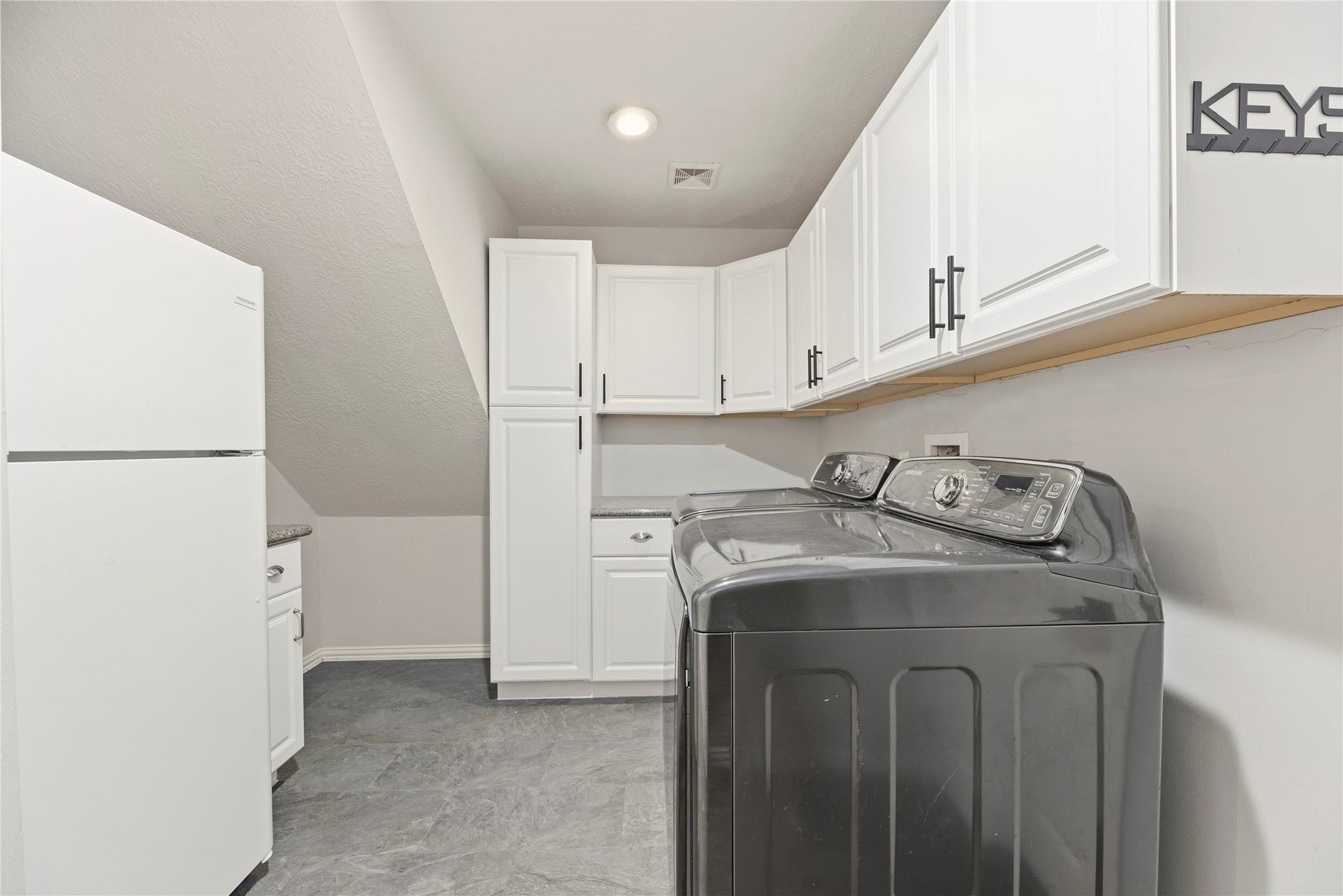 9227 N Fitzgerald Way, Missouri City, TX 77459 Extra large laundry room with room for a fridge, and cabinets to keep storage neat and tidy!