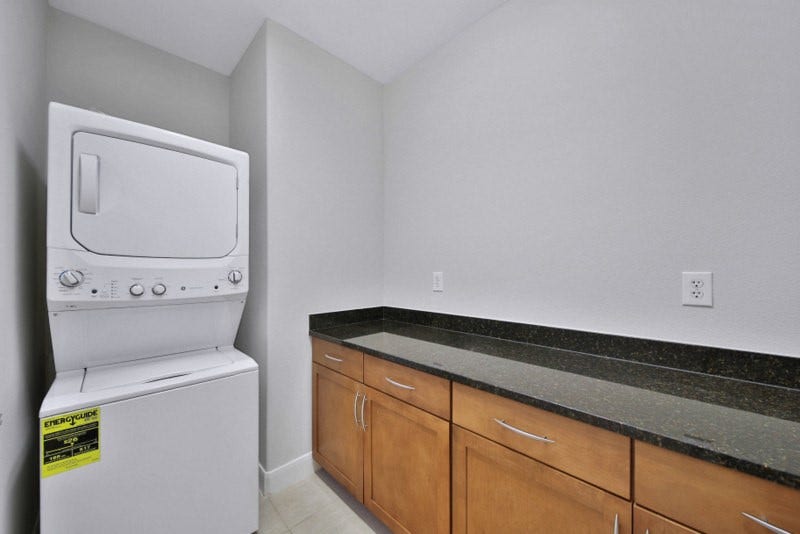 2299 Lone Star Drive, #406, Sugar Land, TX 77479 The view of laundry room W/Cabinets and granite counter-tops.