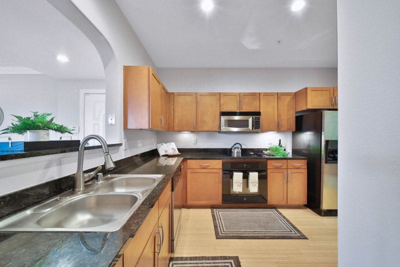 2299 Lone Star Drive, #406, Sugar Land, TX 77479 The view of kitchen W/Granite counter-tops, New cooktop and Stainless Steel appliances.