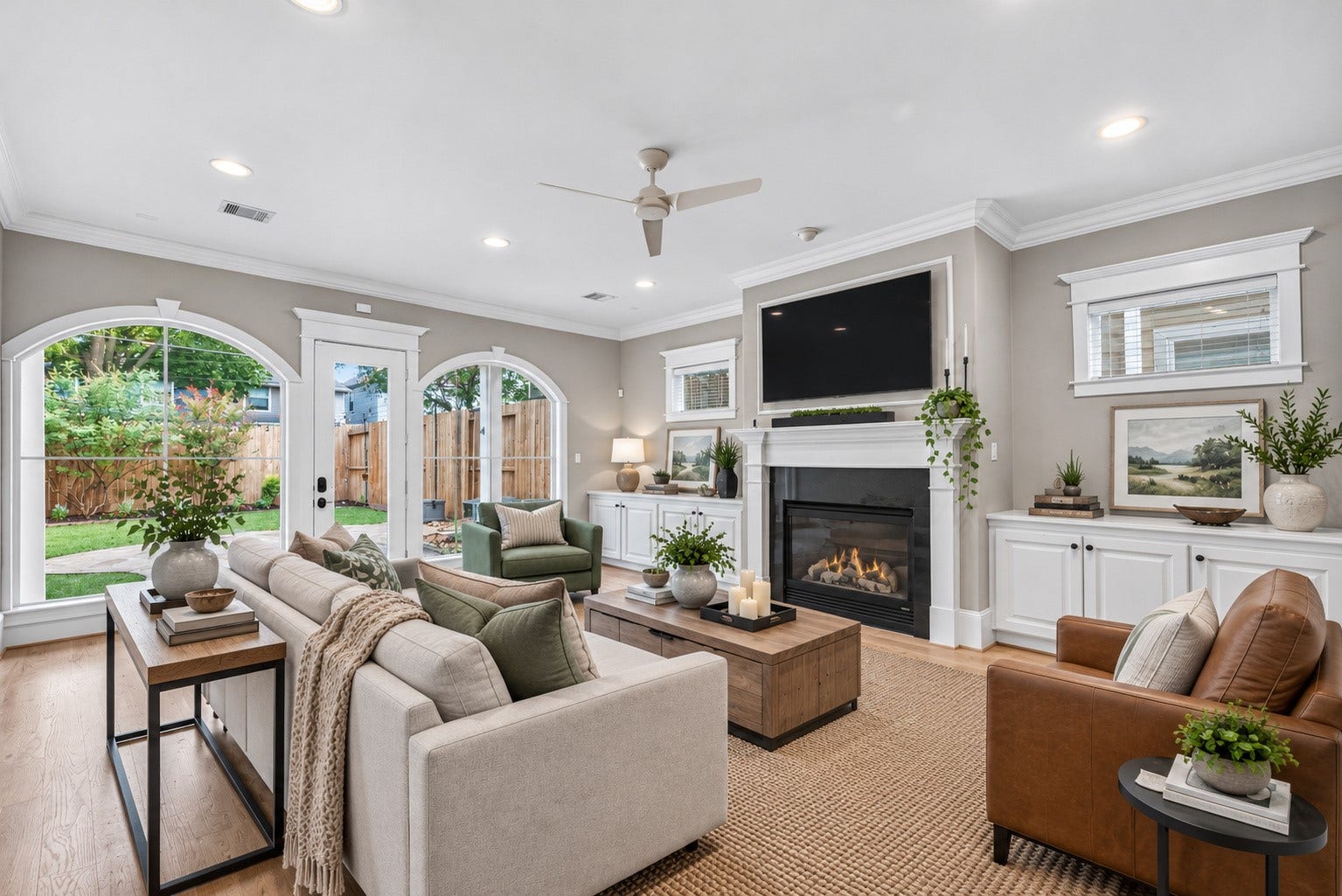 821 W 17th Street, #B, Houston, TX 77008 Dramatic arched windows fill the family room with natural light while framing beautiful views of the private backyard and garden. Presented with a different style of decor digitally imagined.