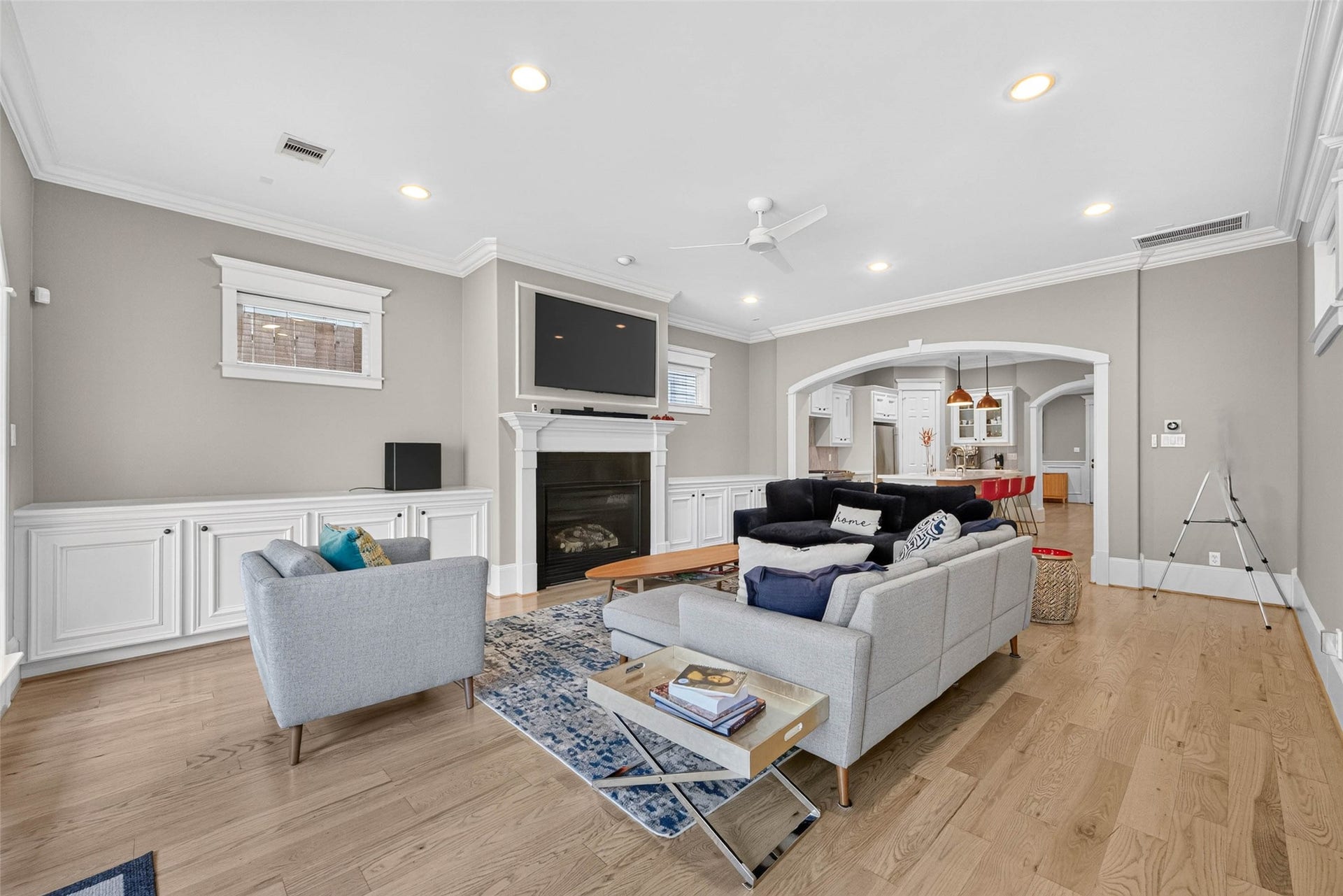 821 W 17th Street, #B, Houston, TX 77008 Custom millwork and a handsome fireplace anchor this spacious living room, while graceful arches connect the heart of the home, the kitchen!