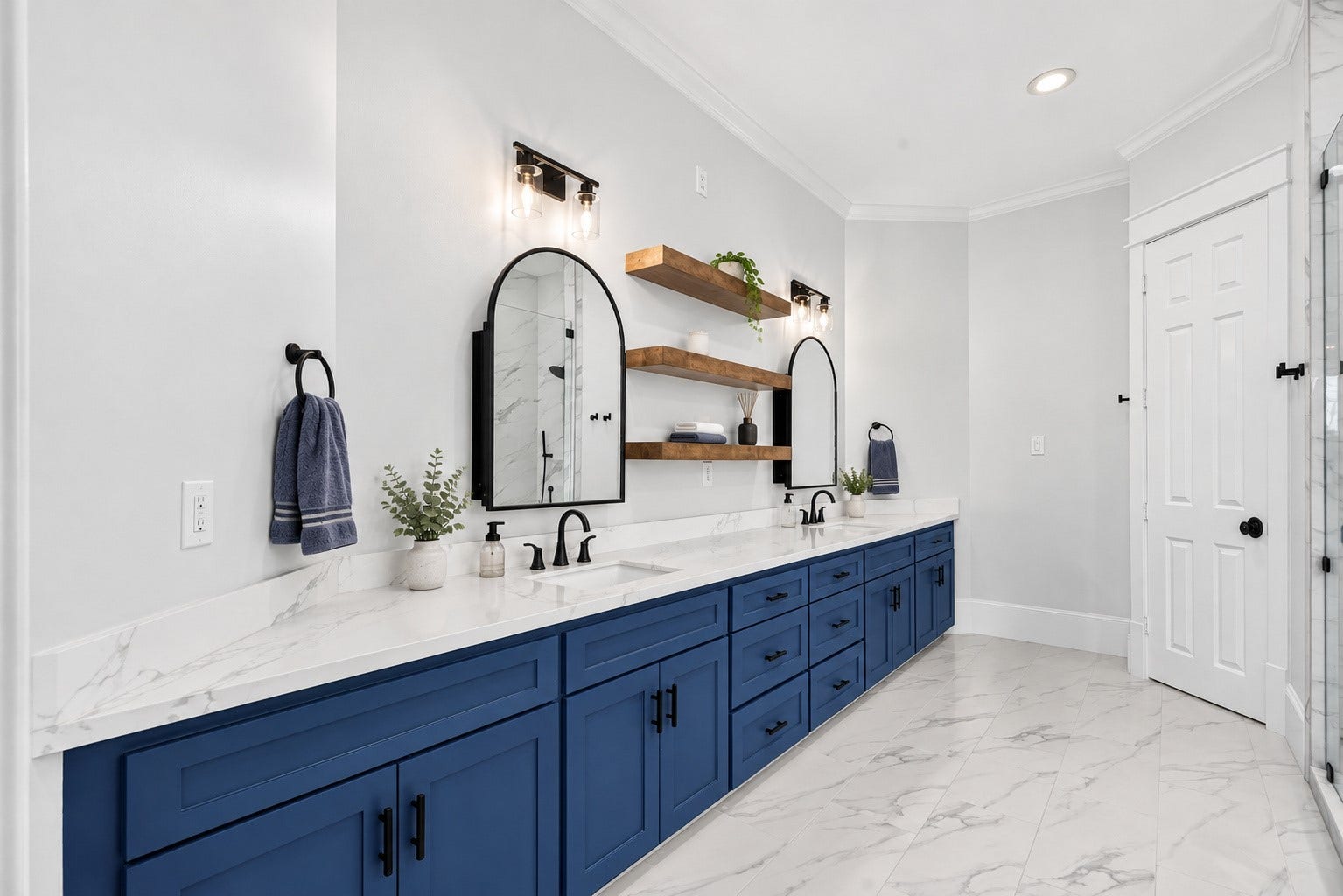 821 W 17th Street, #B, Houston, TX 77008 This beautifully re-envisioned primary bathroom pairs rich blue cabinetry with with an expansive quartz counter, 2 sinks, warm wood accents, abundant storage, designer lighting, and gorgeous mirrors that also open to provide off-counter storage and easy access to your daily necessities!