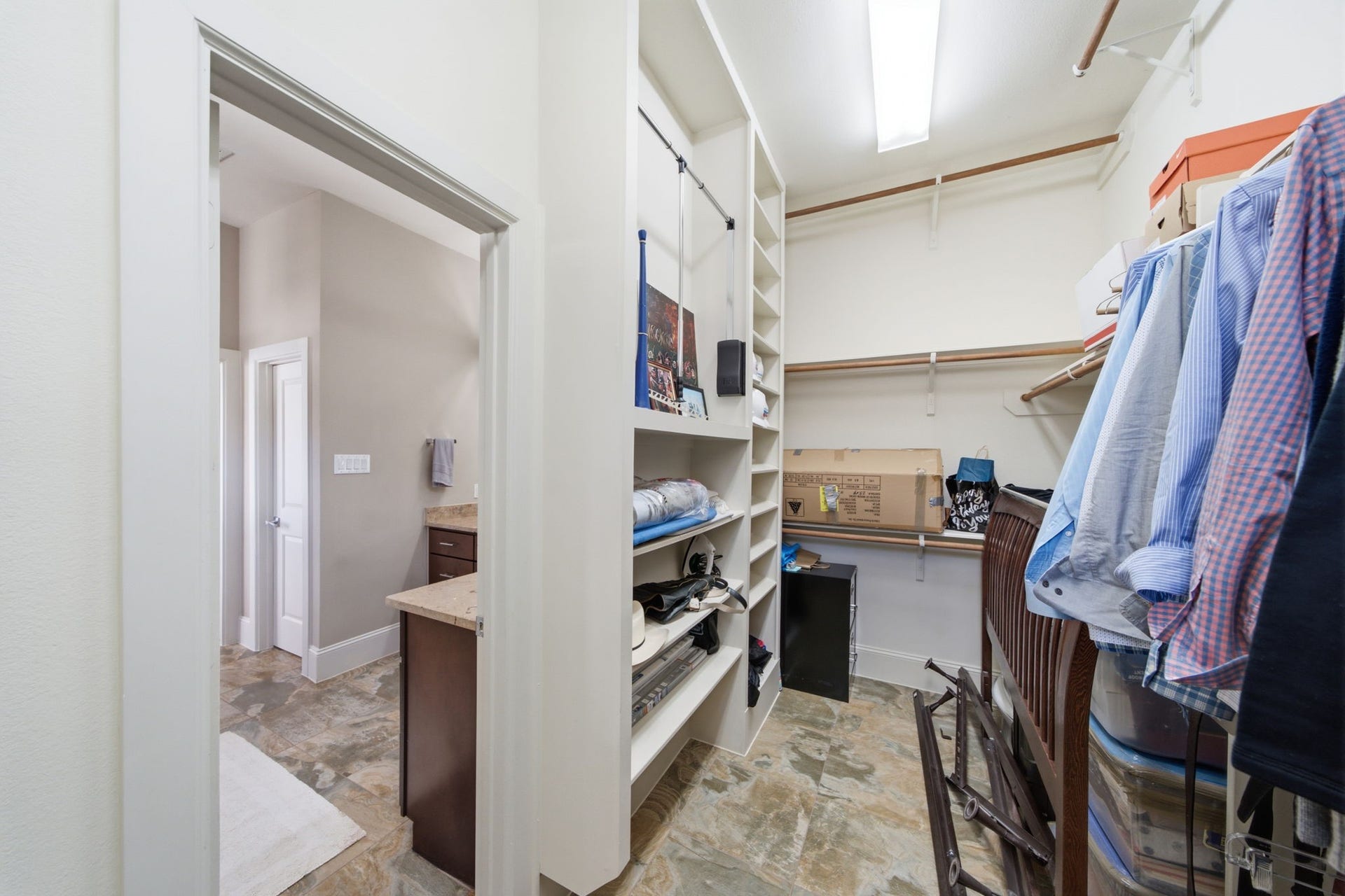 5531 Venice Street, Houston, TX 77007 Large walk in closet with custom built in shelves and a three tier hanging system.