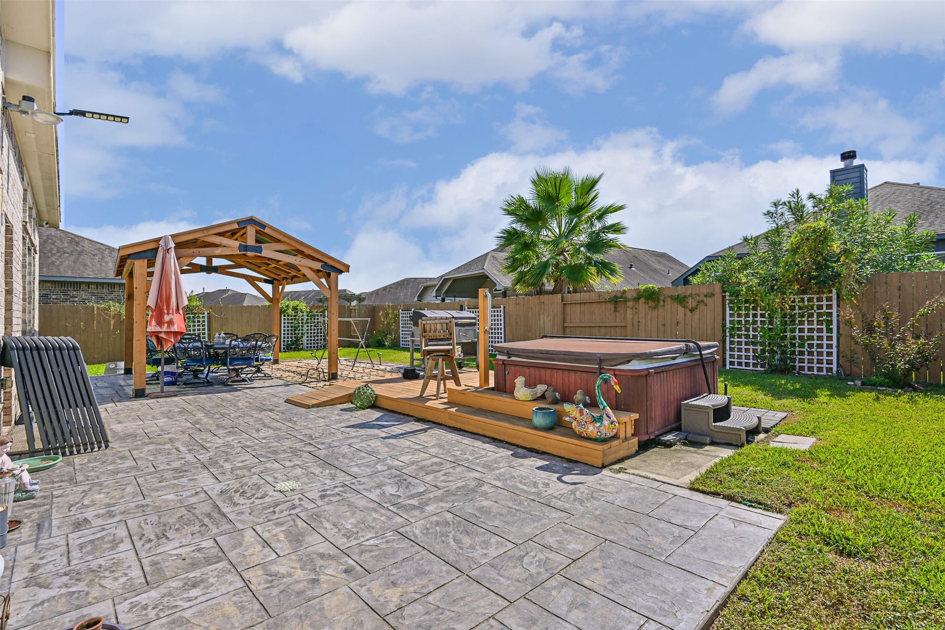 12527 Jetty Cove Drive, Texas City, TX 77568 Another view of the beautifully designed backyard featuring a covered patio, private hot tub, and custom landscaping.