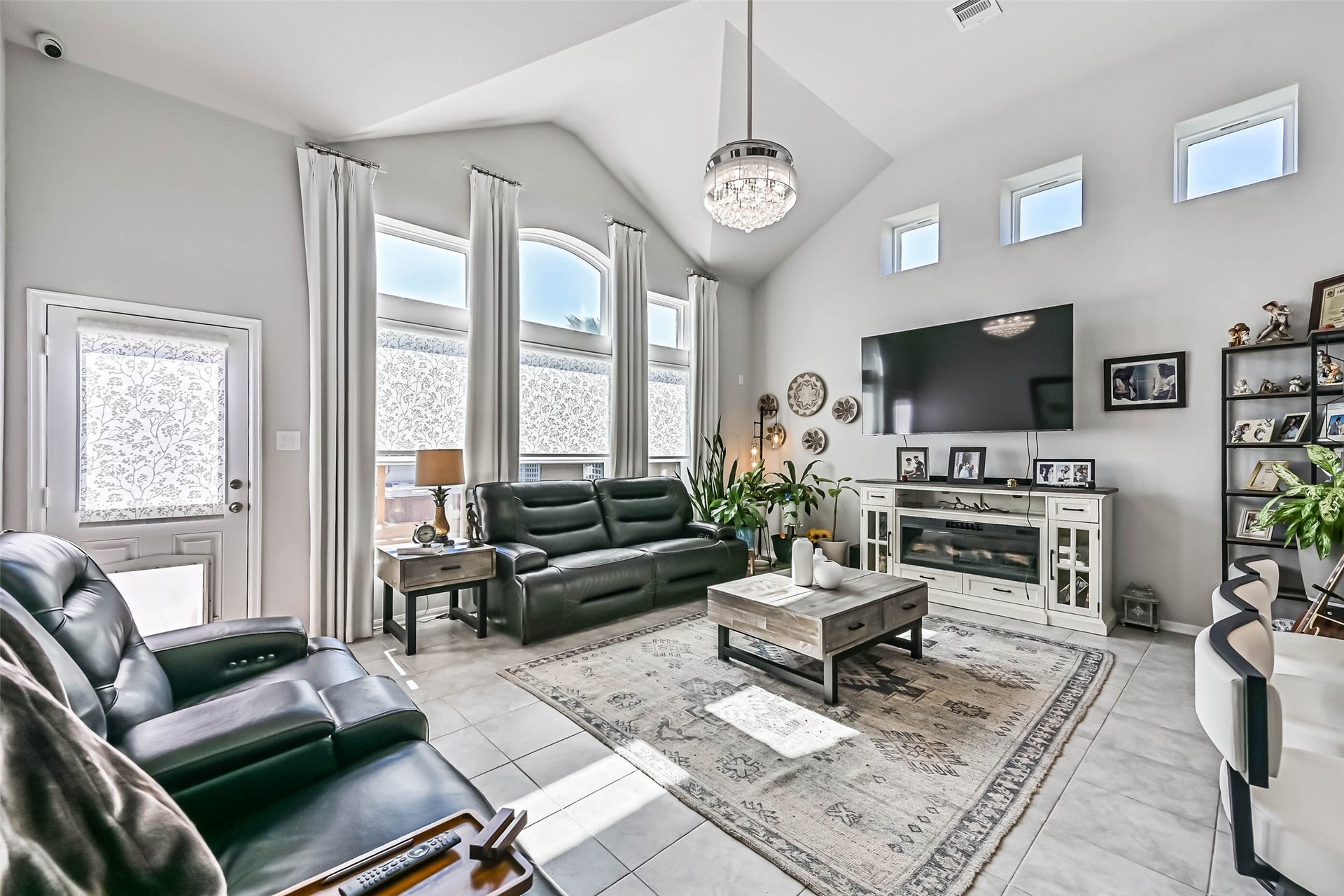 12527 Jetty Cove Drive, Texas City, TX 77568 Bright and inviting living room featuring soaring ceilings, beautiful windows, decorative lighting, and an open, spacious layout.