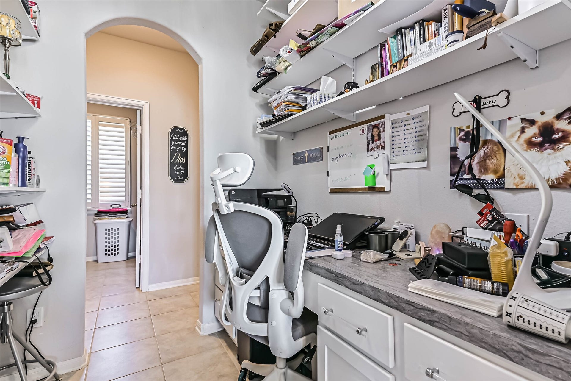 12527 Jetty Cove Drive, Texas City, TX 77568 Convenient built-in workspace off the kitchen with countertop, cabinetry, and open shelving, ideal for a home office or household organization.