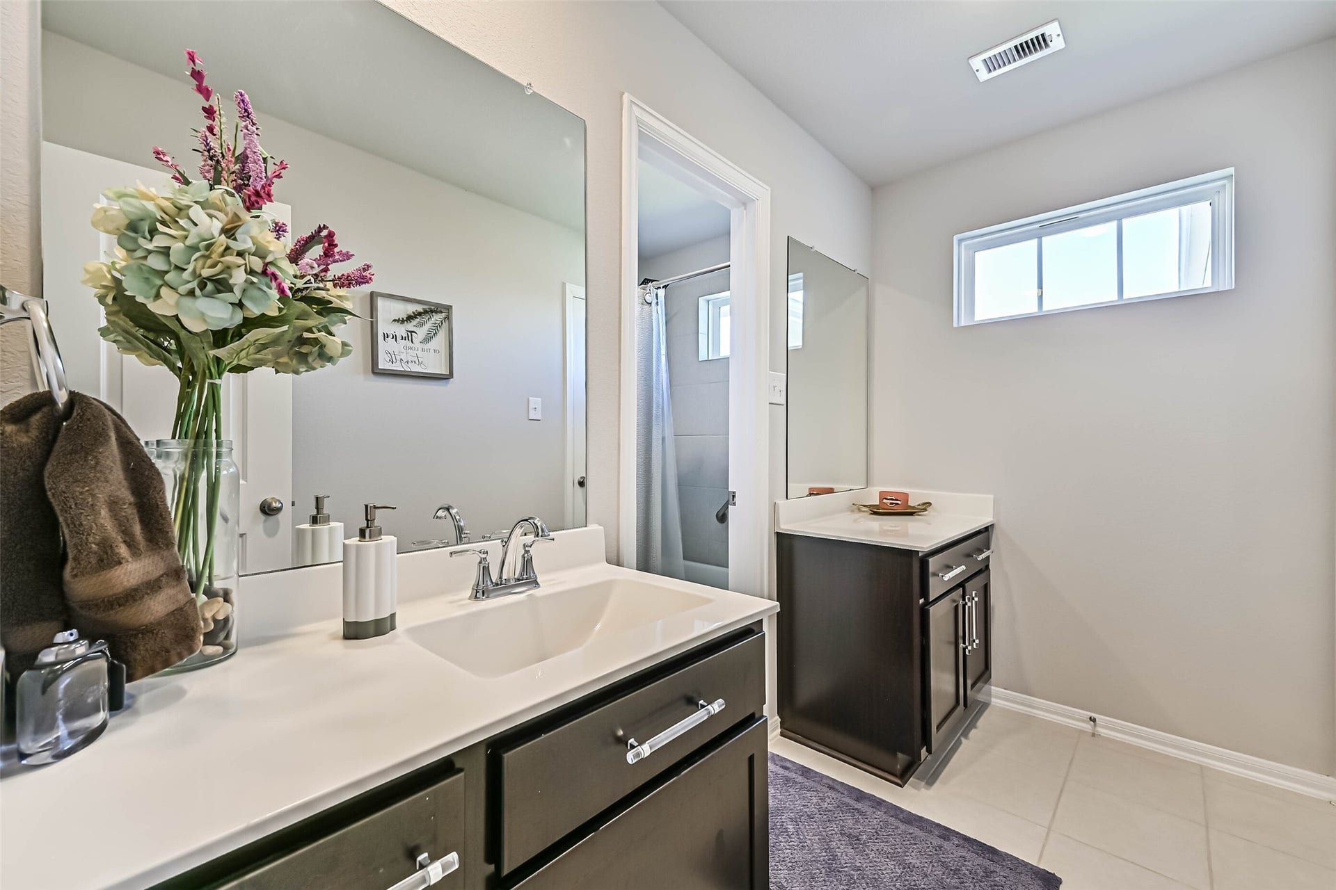 12527 Jetty Cove Drive, Texas City, TX 77568 Spacious upstairs bathroom with dual vanities, ample cabinet storage, and a separate shower area.