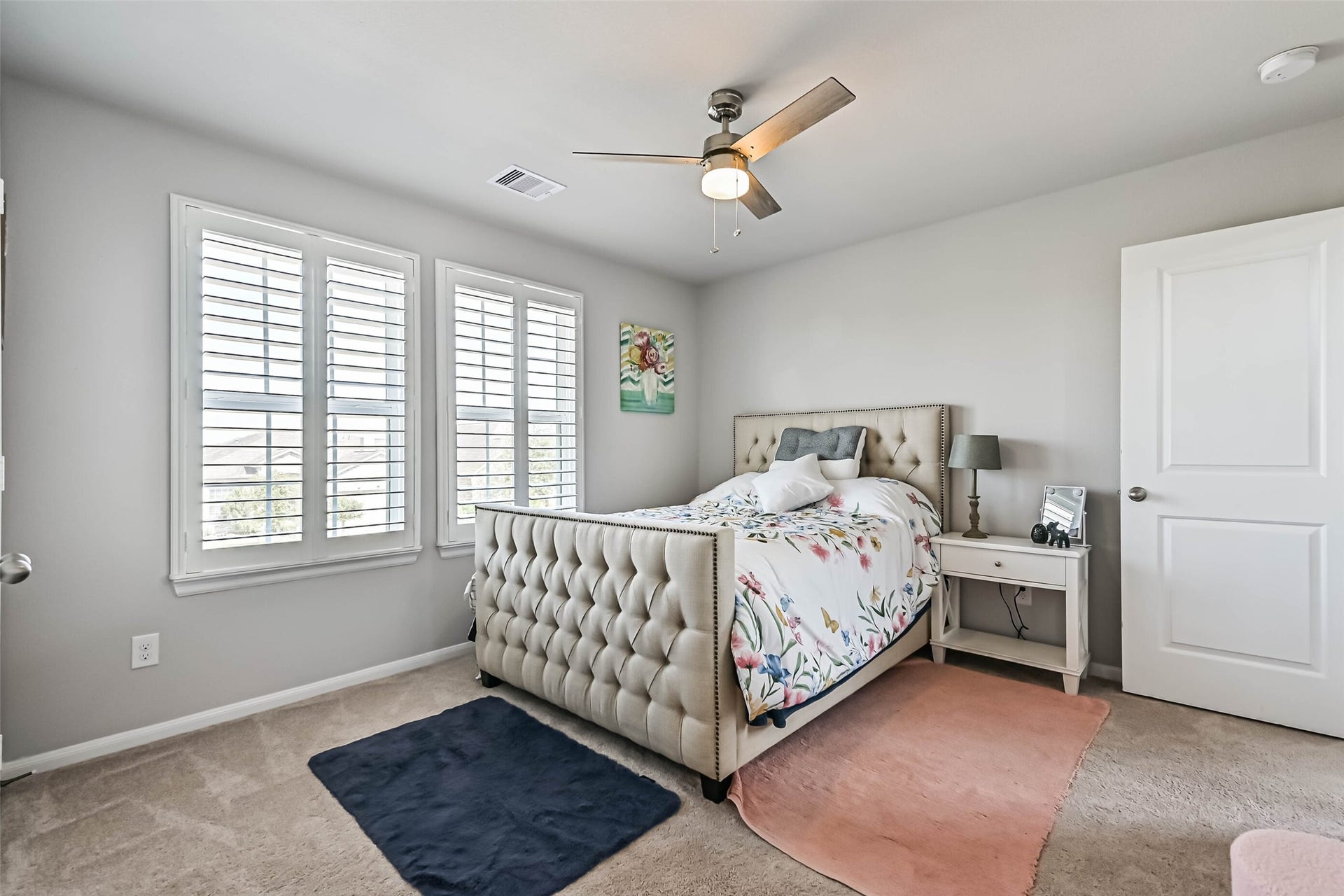12527 Jetty Cove Drive, Texas City, TX 77568 Another view of the bedroom showcasing its generous layout, plantation shutters, and neutral finishes.