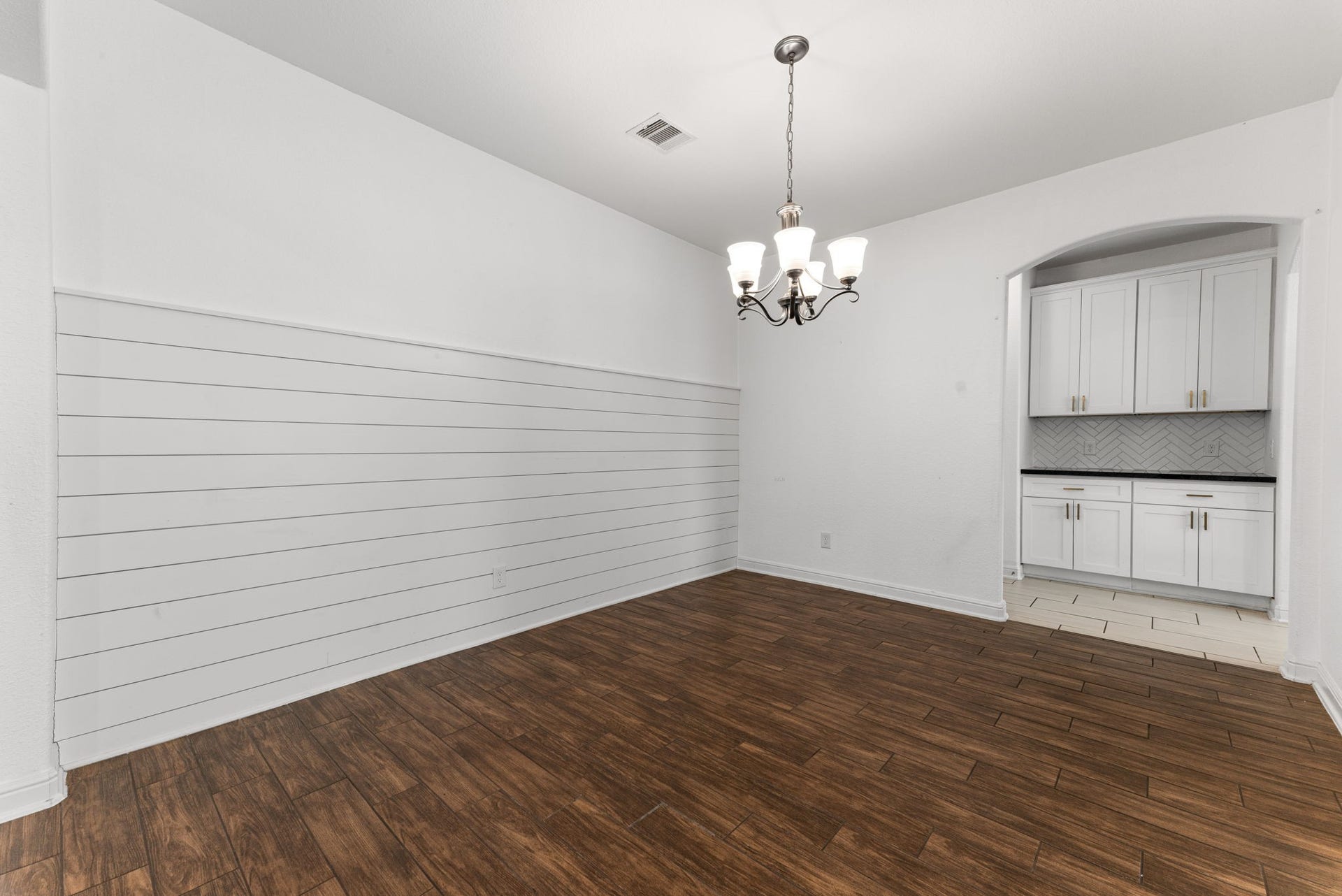 23827 Padauk Tree Trail, Katy, TX 77493 Host dinner parties or enjoy a weeknight meal in this formal dining area with a shiplap accent wall, chandelier and built-in white cabinetry that gives you style and storage in one.