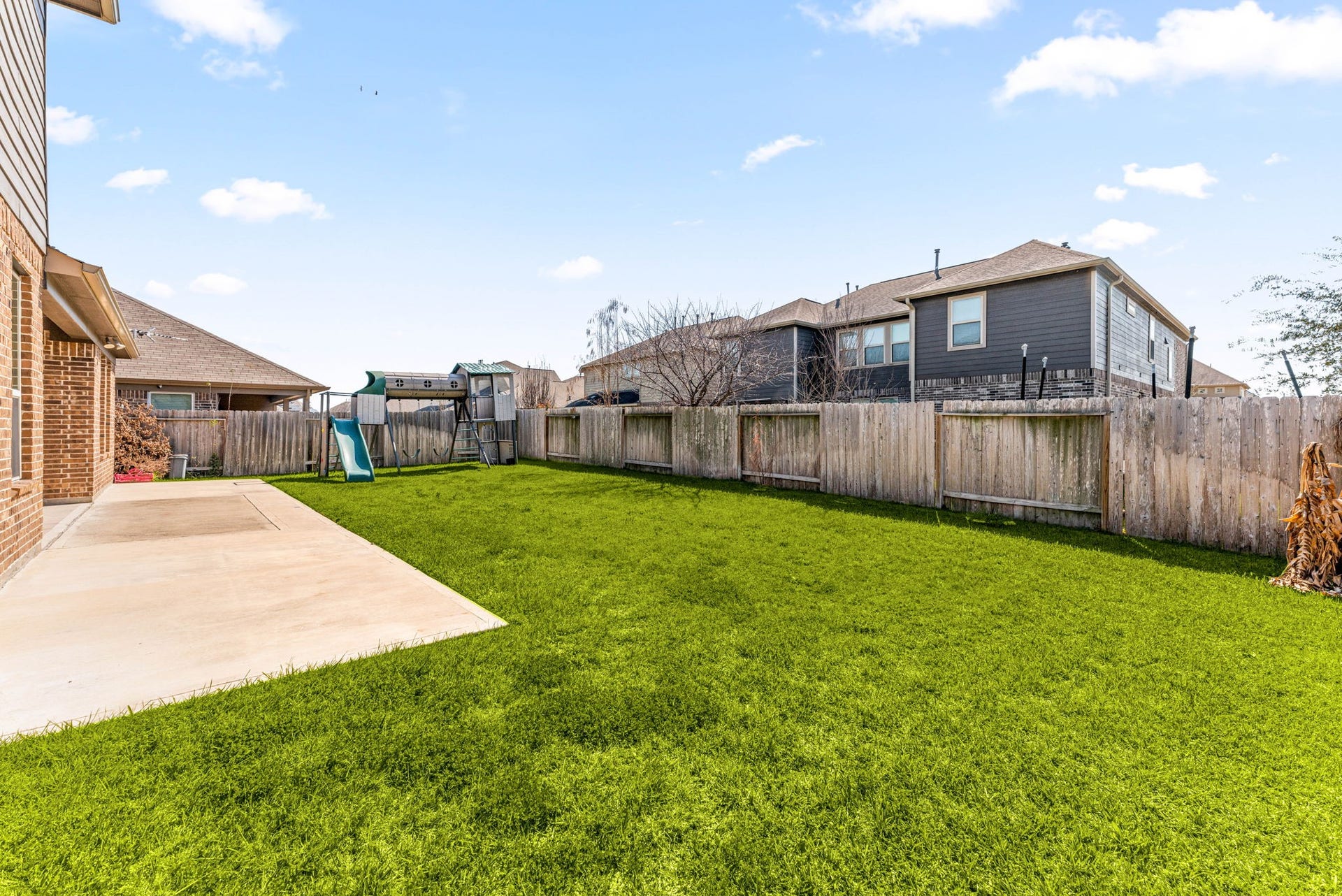 23827 Padauk Tree Trail, Katy, TX 77493 A wider view of the backyard showing just how much space there is, plenty of grass, a solid fence for privacy and room for anything from a garden to a pool down the road.