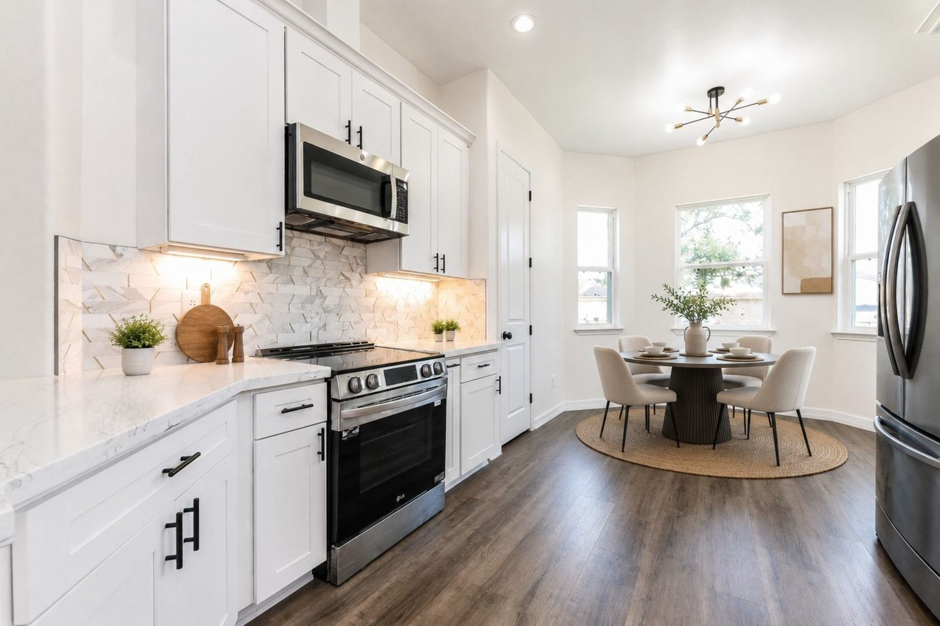 Bright and modern kitchen with sleek white cabinetry, stainless steel appliances, and a cozy dining area filled with natural light.
Stage Breakfast