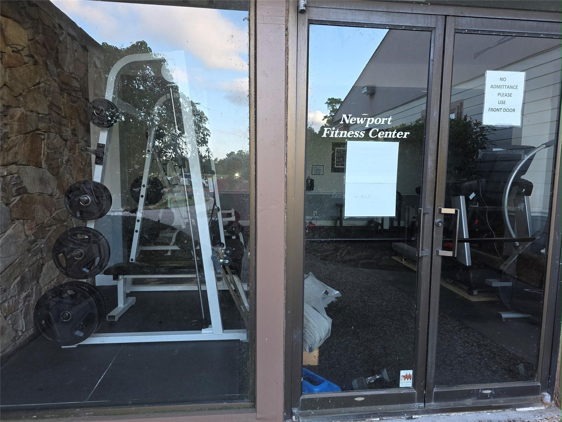 Fitness center equipped with weightlifting equipment and cardio machines, offering a convenient workout space.