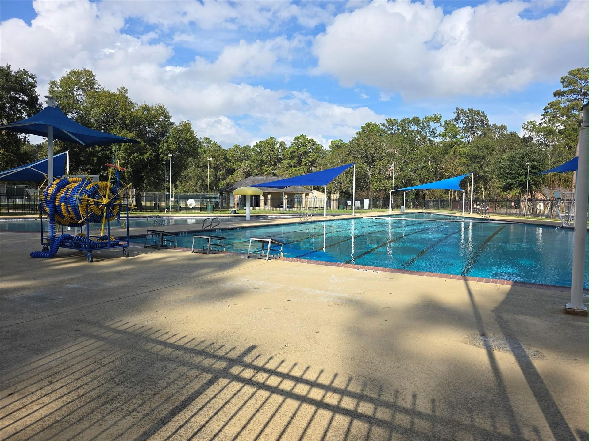 Enjoy a spacious community pool with shaded areas and a fun water play zone, perfect for relaxation and family activities amidst a serene natural backdrop.