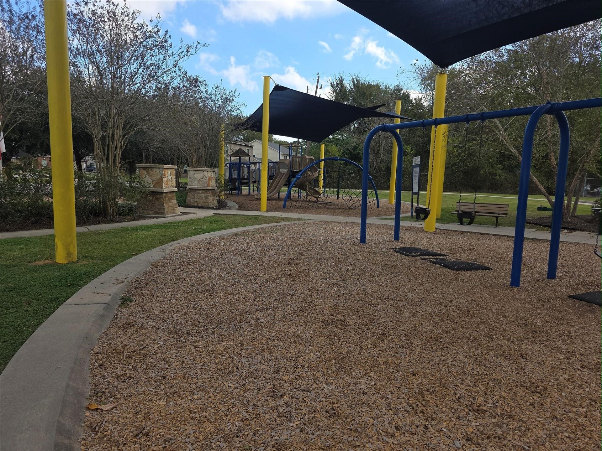 Charming community playground with swings, slides, and shaded areas, perfect for family fun and outdoor activities.