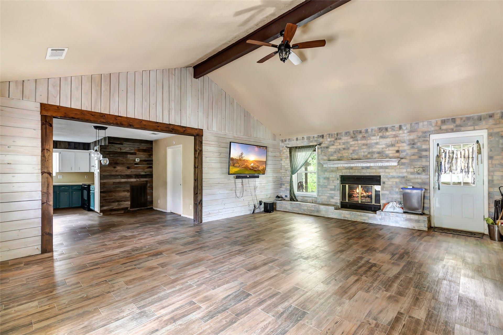3005 Kindt Drive, Dayton, TX 77535 Living area with wood look tile flowing into kitchen area
