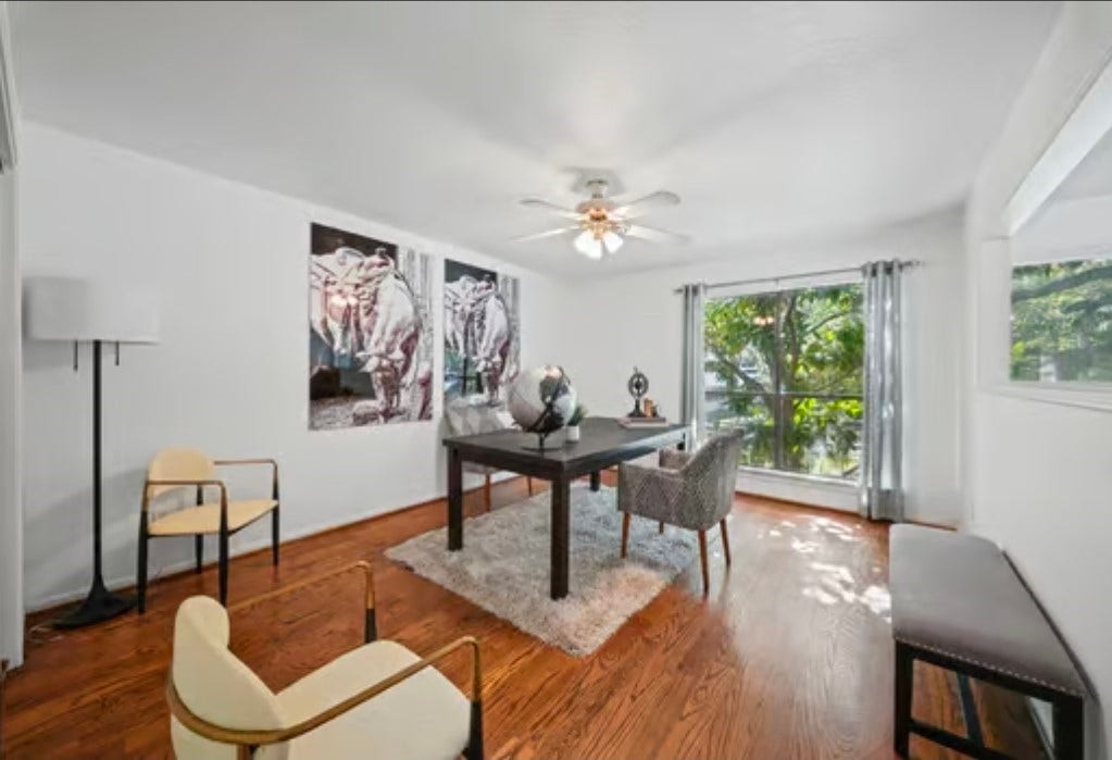 2555 Bering Drive, #1, Houston, TX 77057 The 2nd bedroom offers hardwood floors, large windows for natural light. Here it's being used as an inviting home office with modern decor, offering a quiet atmosphere for a more productive working environment