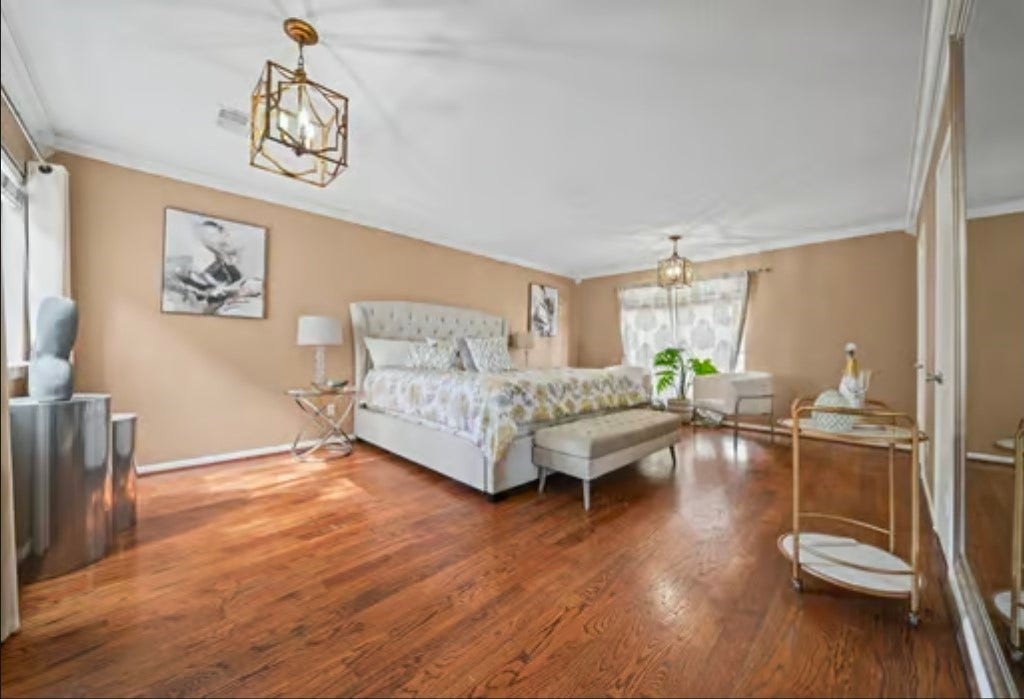 2555 Bering Drive, #1, Houston, TX 77057 Spacious primary owners suite bedroom has rich hardwood floors, has large closet space, and ample natural light from large windows.