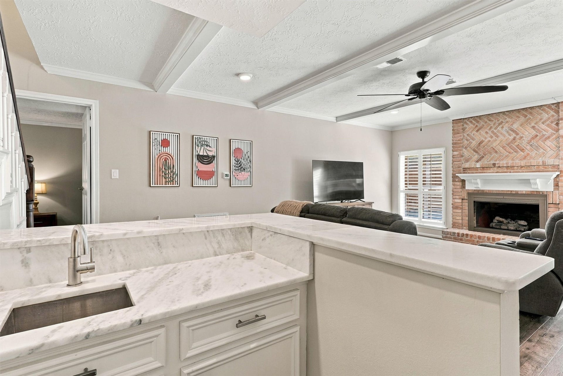 1030 Barkston Drive, Katy, TX 77450 A closer look at the wet bar showcases its updated granite counters, crisp white cabinetry, and a convenient sink, making it perfect for hosting and entertaining guests.