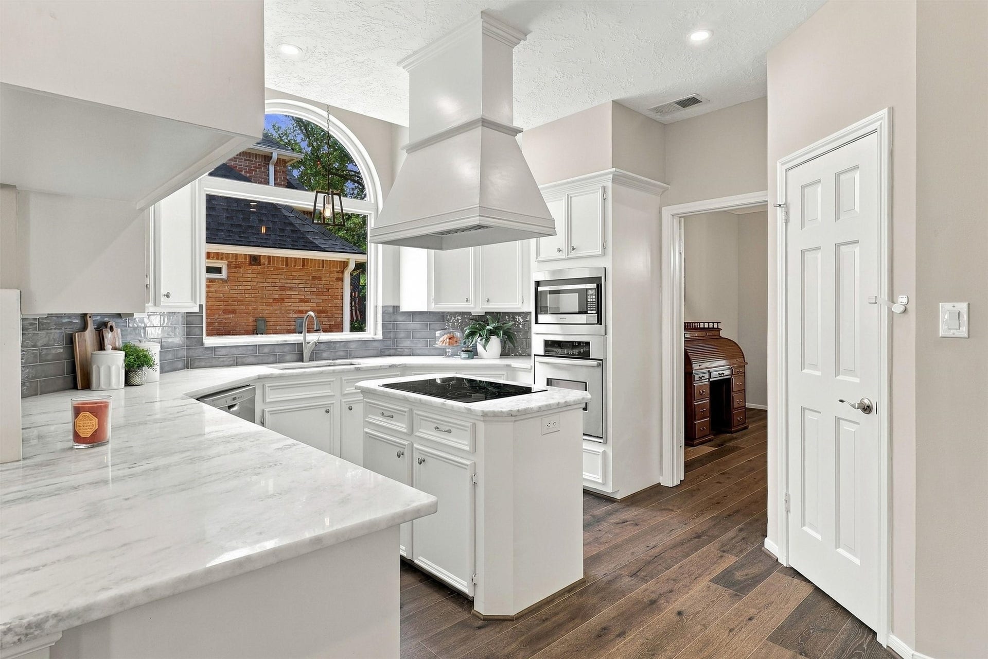 1030 Barkston Drive, Katy, TX 77450 Other features in this kitchen include a built in wall oven with a microwave above, along with expansive countertop space that is perfect for prepping your favorite meals. A walk in pantry rounds out this well appointed space.