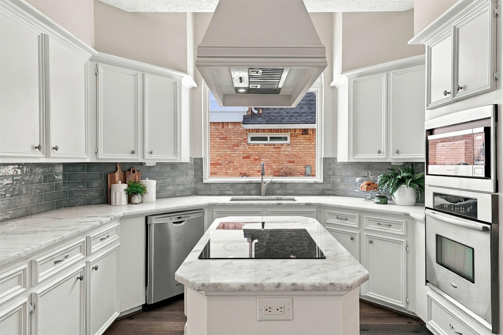 1030 Barkston Drive, Katy, TX 77450 The kitchen is truly a dream space, featuring crisp white cabinetry, a stylish tile backsplash, and stunning granite countertops throughout, along with so many more thoughtful details.