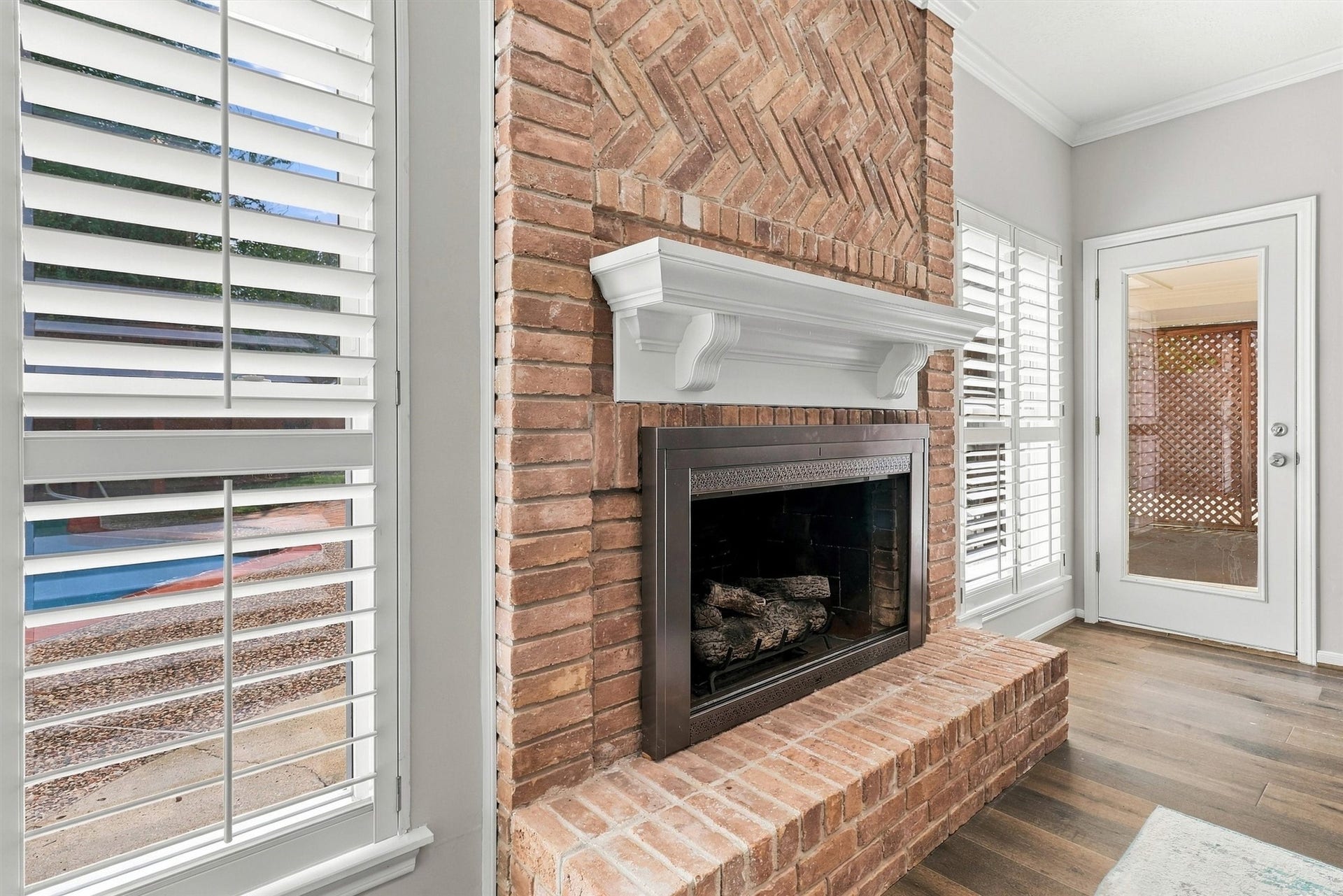 1030 Barkston Drive, Katy, TX 77450 The fireplace serves as a striking focal point in this room, framed beautifully between picture windows dressed in plantation shutters. This gas log fireplace makes it easy to have a cozy fire going in seconds!