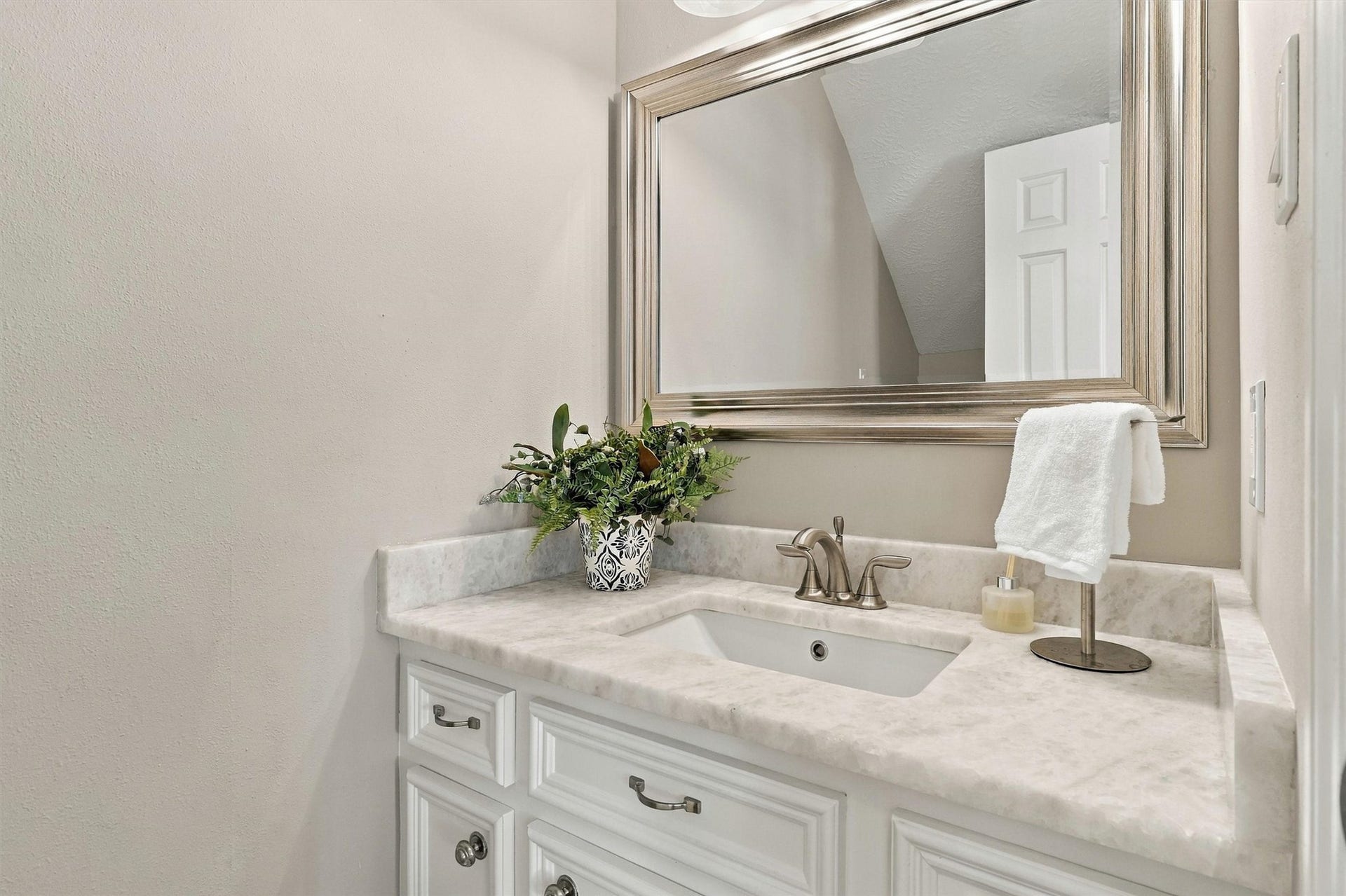 1030 Barkston Drive, Katy, TX 77450 The powder bathroom offers a spacious vanity with granite counters, a framed mirror, nickel finishes, and so much more. This convenient half bathroom completes the downstairs living space.