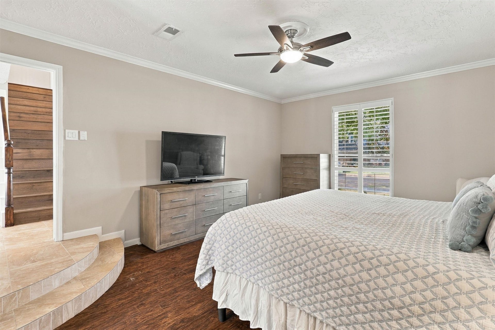 1030 Barkston Drive, Katy, TX 77450 The steps from the foyer continue seamlessly into the primary bedroom, adding a wonderful sense of character and uniqueness to the home.