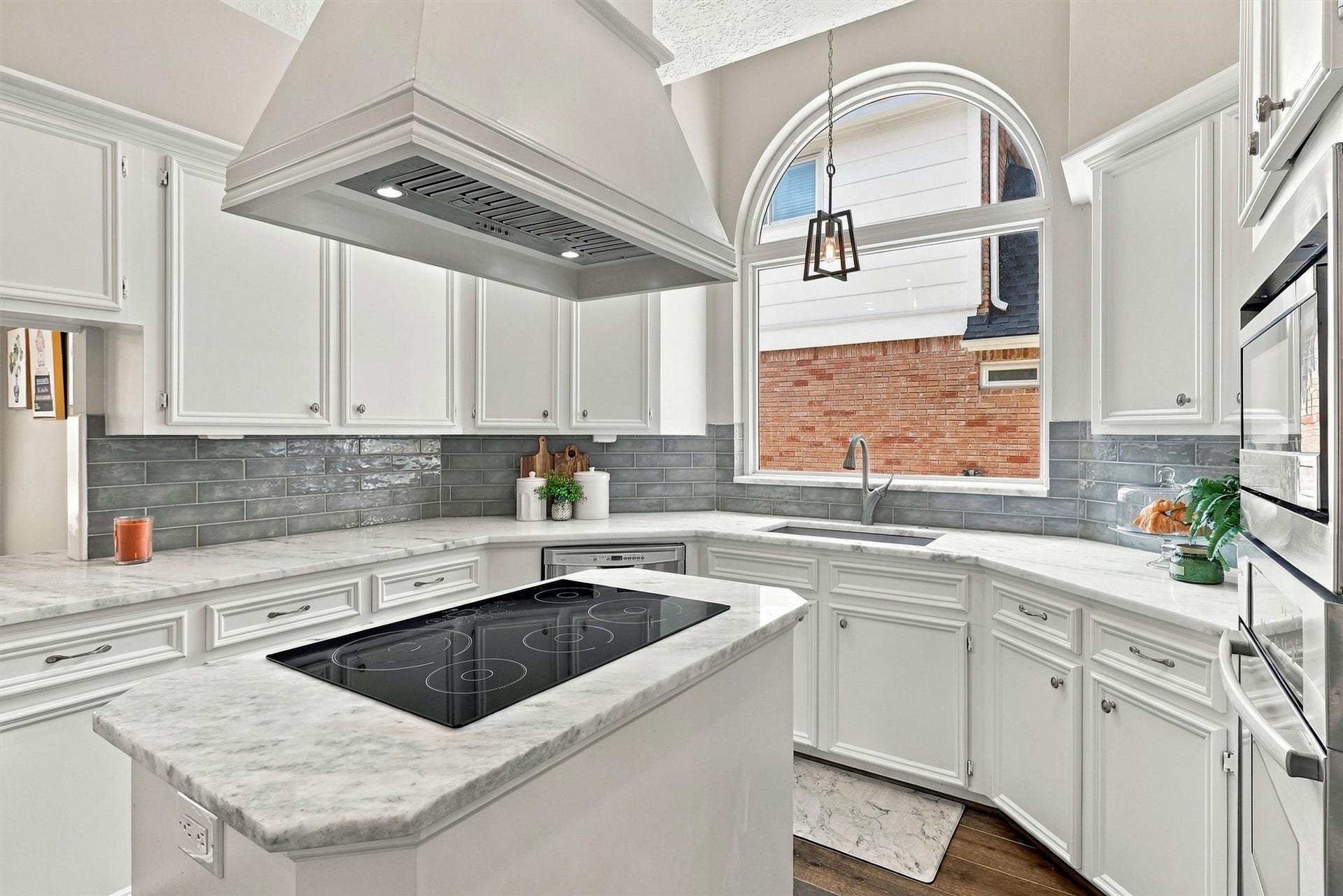 1030 Barkston Drive, Katy, TX 77450 Back in the kitchen, this functional and beautiful island features an electric cooktop beneath a stunning vent hood, serving as the focal point of the room.