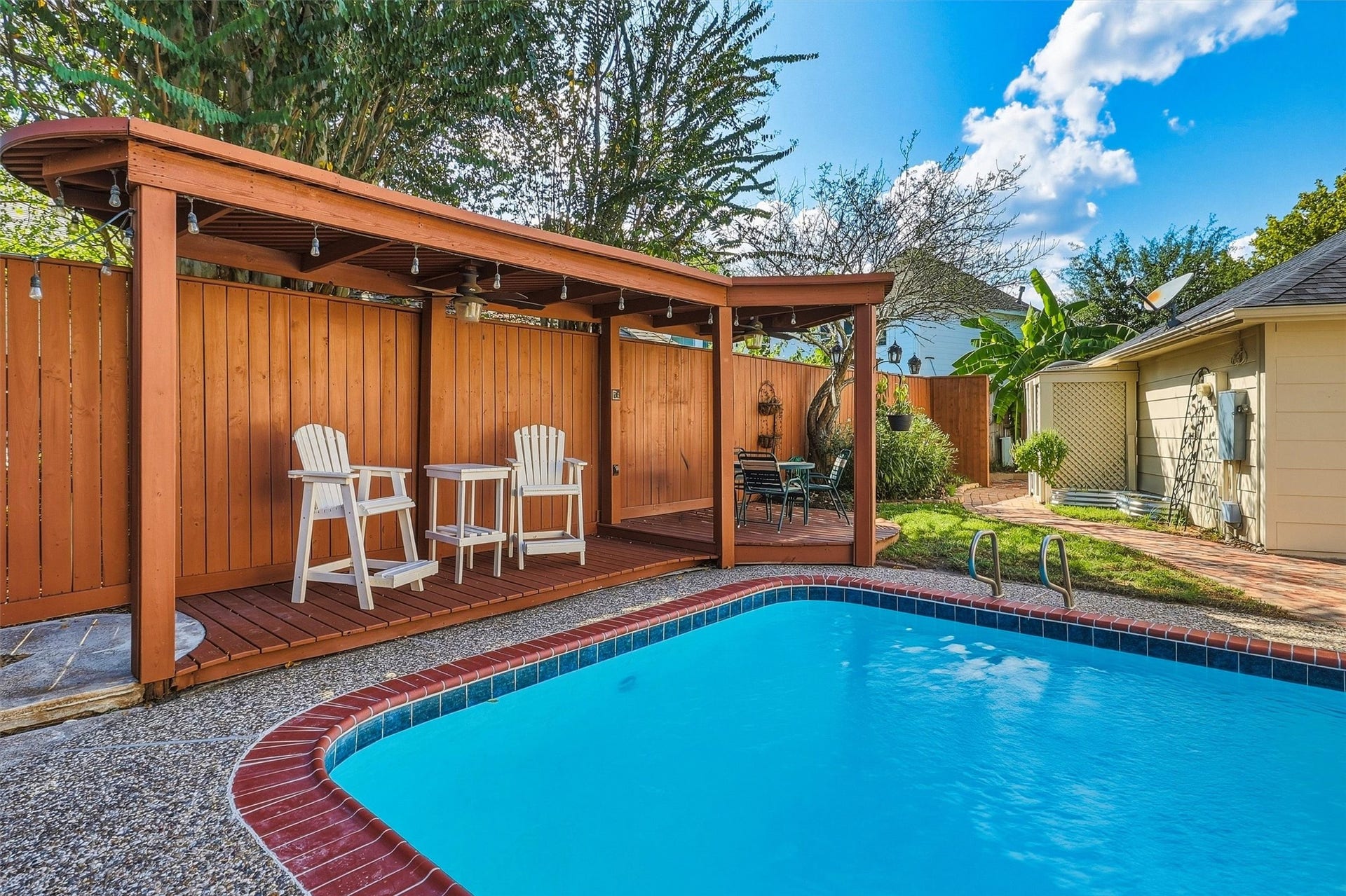 1030 Barkston Drive, Katy, TX 77450 Relax and unwind under the covered deck by the pool after spending time swimming in this beautiful backyard oasis.