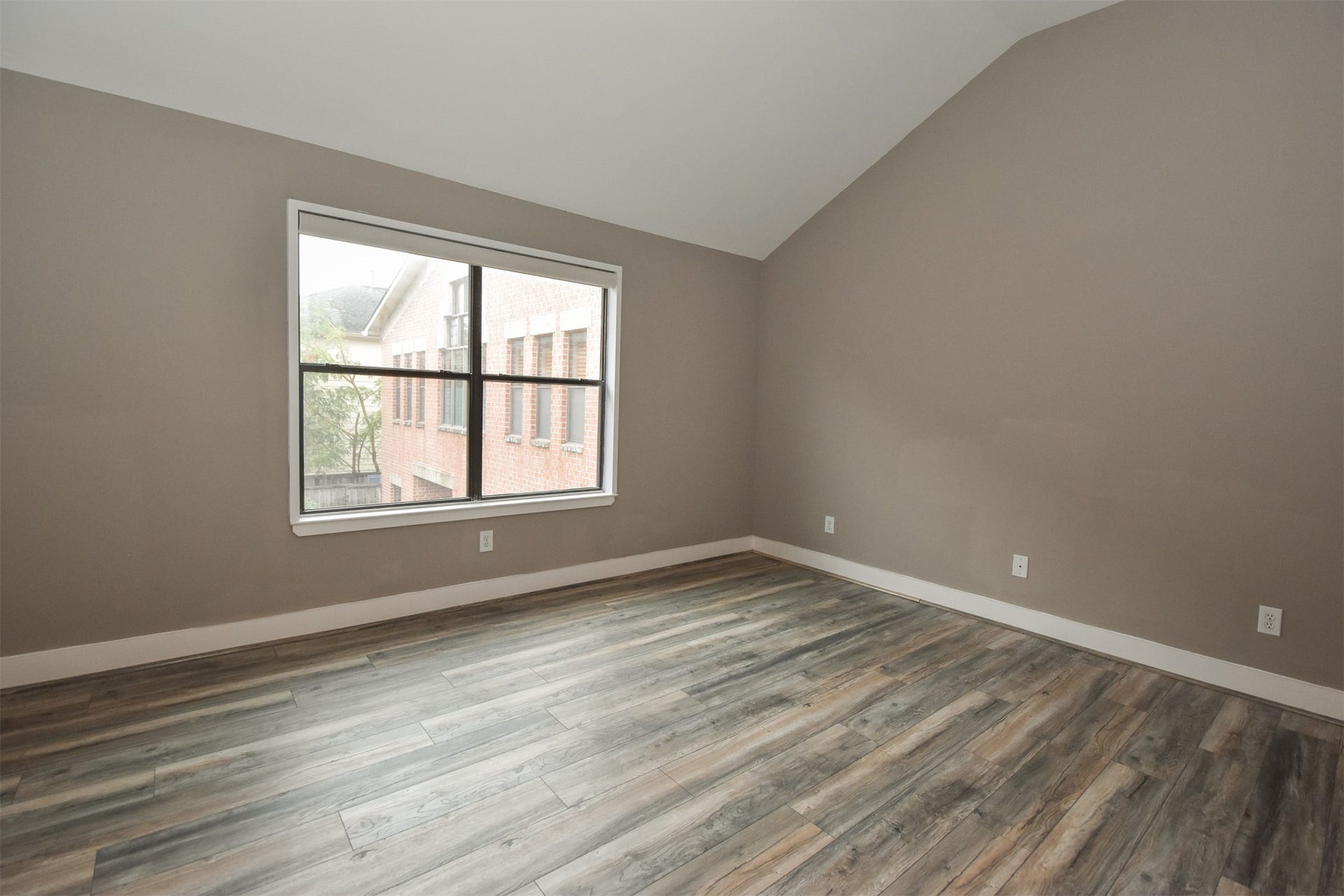 5710 Cornish Street, #1, Houston, TX 77007 Spacious Primary Bedroom. Note the updated laminated floor & fresh paint throughout the second floor.
