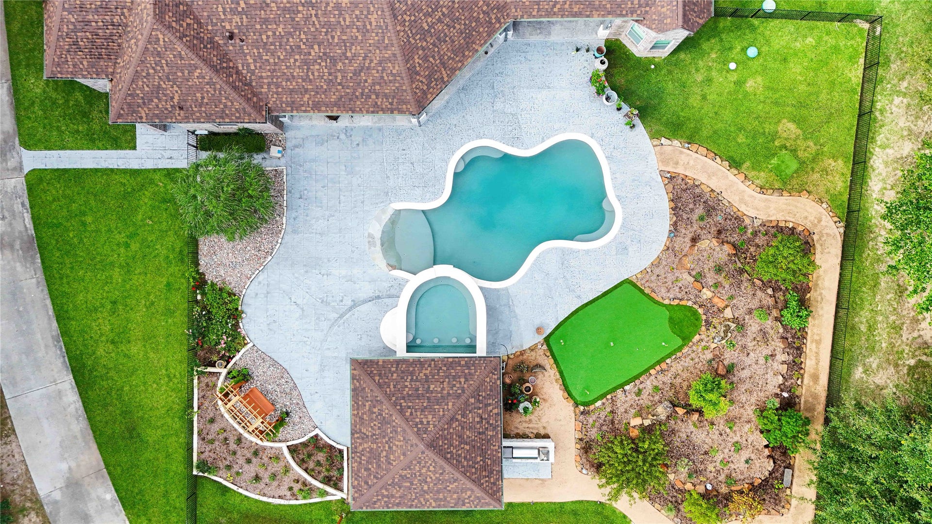 Large Salt Water pool with a beach entrance and swim up bar hot tub
