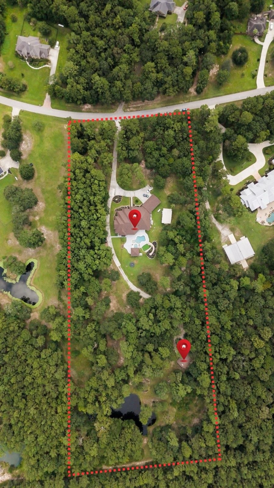 Drone image of the property showcasing the 10 acres, main house, guest house, pond, and outdoor entertainment area