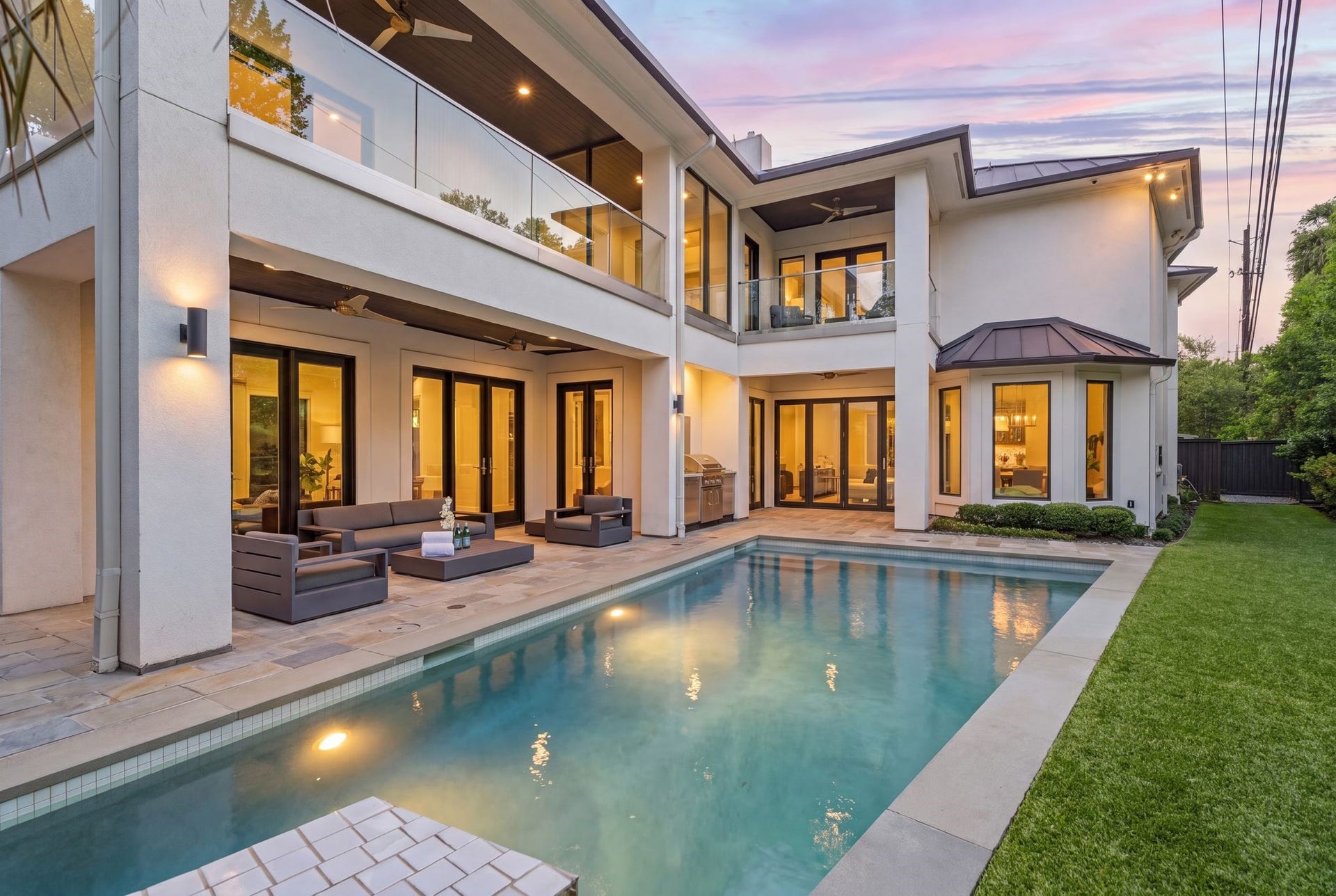 3703 Wroxton Road, West University Place, TX 77005 Your private outdoor retreat features a resort-style pool, covered patio, summer kitchen, and multiple balconies overlooking the backyardcreating the perfect setting for year-round entertaining and relaxation.
