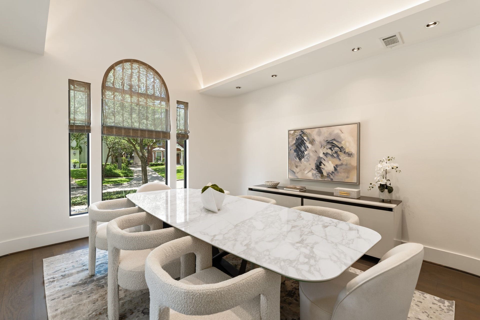 3703 Wroxton Road, West University Place, TX 77005 Elegant formal dining room with soaring ceilings, dramatic arched windows, and abundant natural lightan inviting space designed for intimate dinners and memorable celebrations.