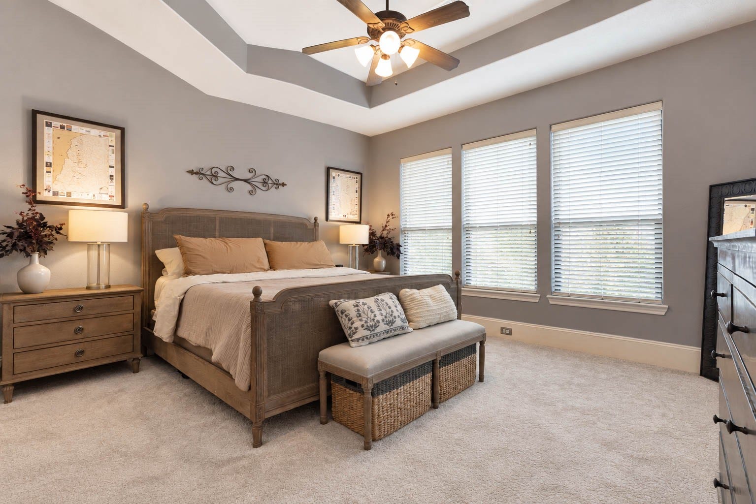 1316 Studer Street, Houston, TX 77007 The spacious second-floor primary suite offers a comfortable private retreat with a high, tray ceiling, soft carpeting, ceiling fan, and a wide bank of windows bringing in generous natural light.