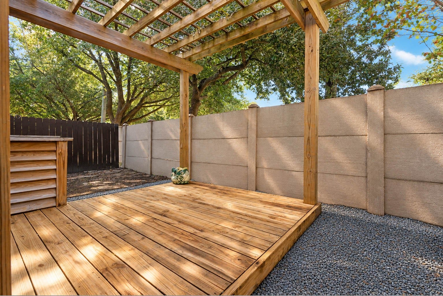 1316 Studer Street, Houston, TX 77007 Step outside to a surprisingly private outdoor retreat featuring an expansive wood deck surrounded by mature trees and fencing.