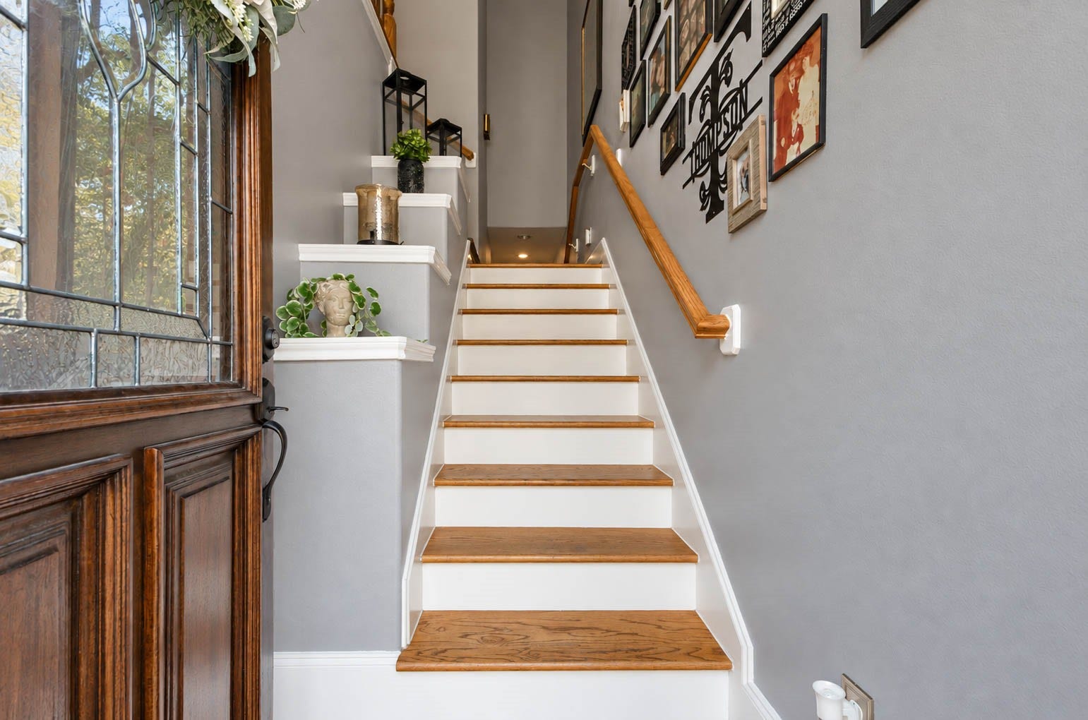 1316 Studer Street, Houston, TX 77007 The staircase becomes an architectural feature of its own, pairing warm wood treads with tiered display platforms. The open design enhances the sense of space and provides a graceful transition to the rest of the home.