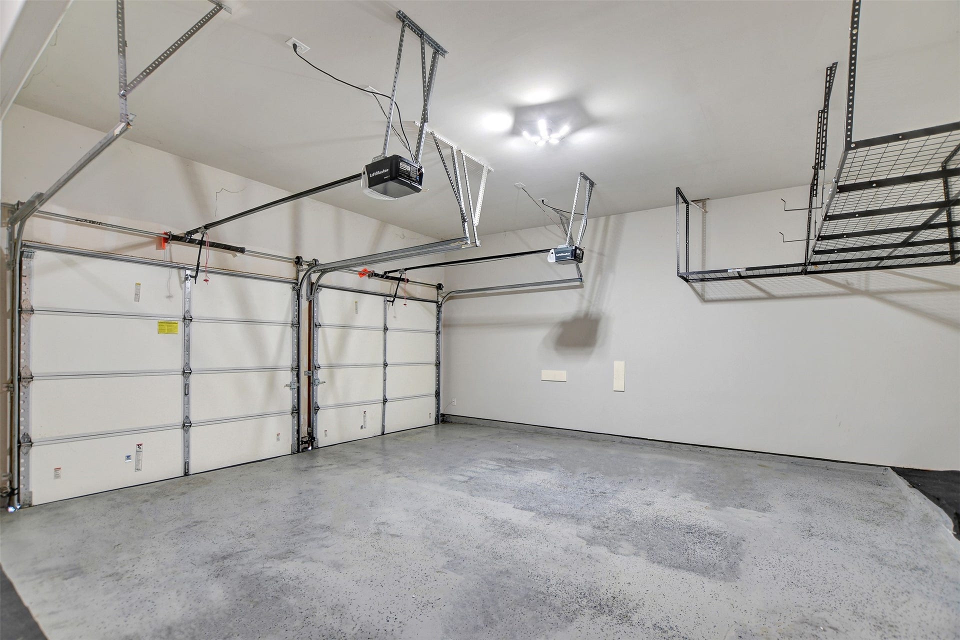 23623 San Ricci Court, Richmond, TX 77406 2.5 garage with storage racks and epoxy flooring.