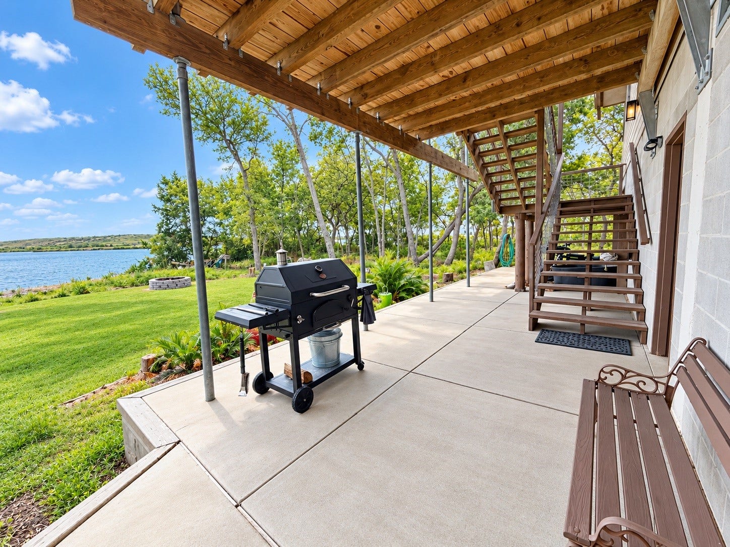 4207 Tri City Beach Road, Baytown, TX 77523 Enjoy serene lakeside views from this spacious patio, featuring a covered area perfect for outdoor entertaining.