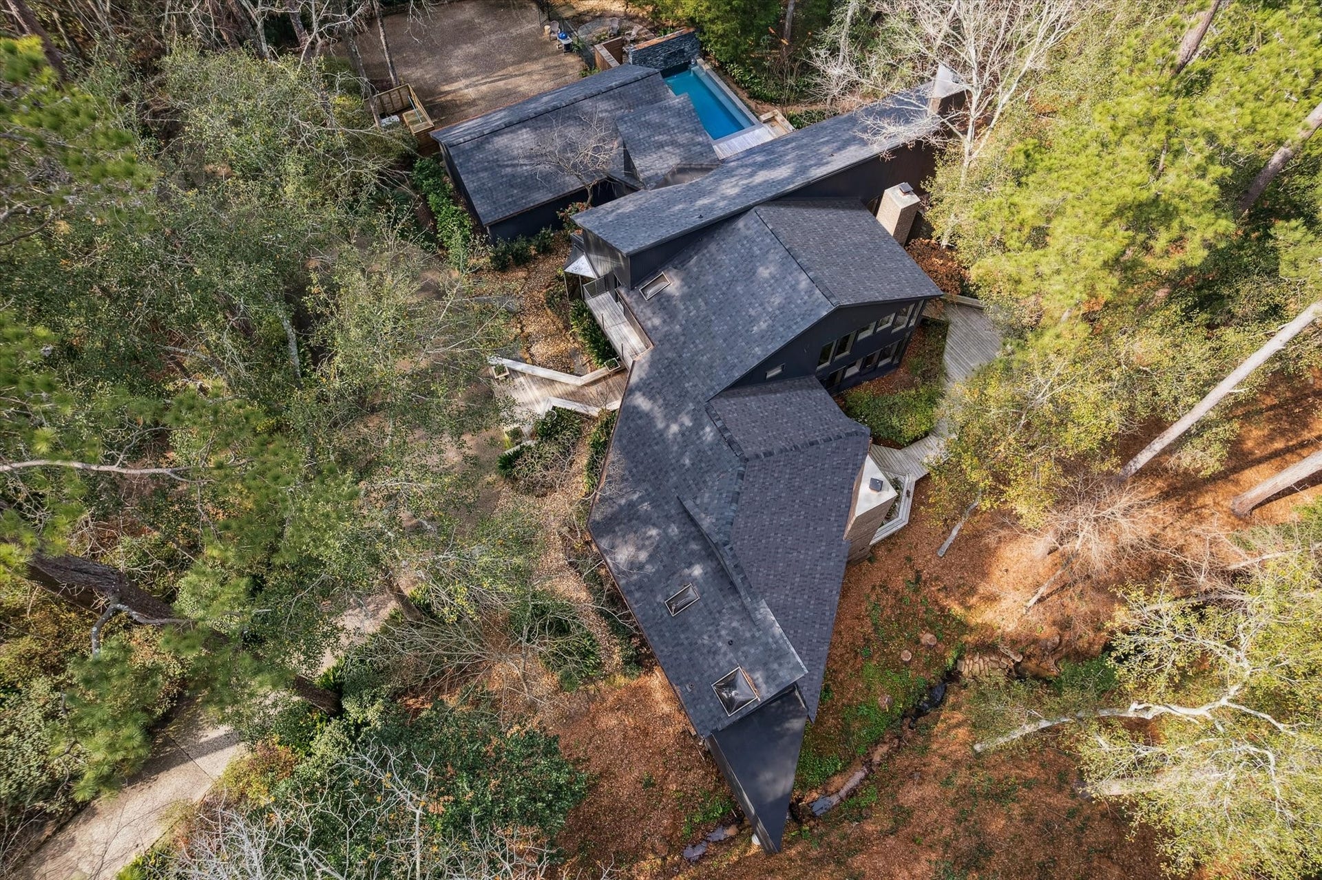 23414 Holly Hollow Street, Tomball, TX 77377 Rare architectural treasure tucked among mature trees, creating a serene, elevated treehouse hideaway.