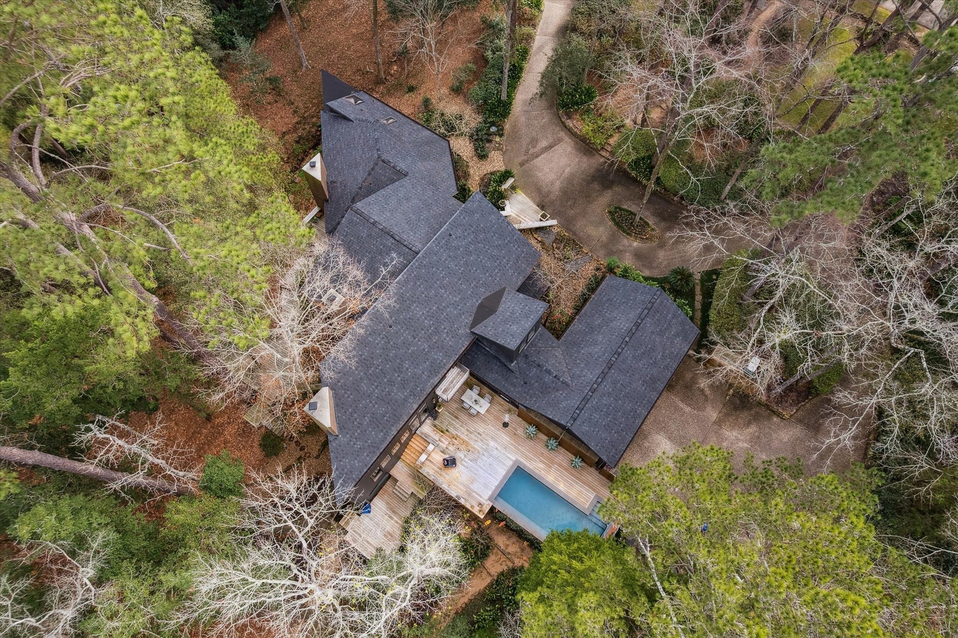 23414 Holly Hollow Street, Tomball, TX 77377 Truly one-of-a-kind architectural gem, tucked beneath a lush canopy of mature trees and offering the peaceful, elevated feel of a private treehouse retreat, quietly nestled within the prestigious Holly Creek Estates community.