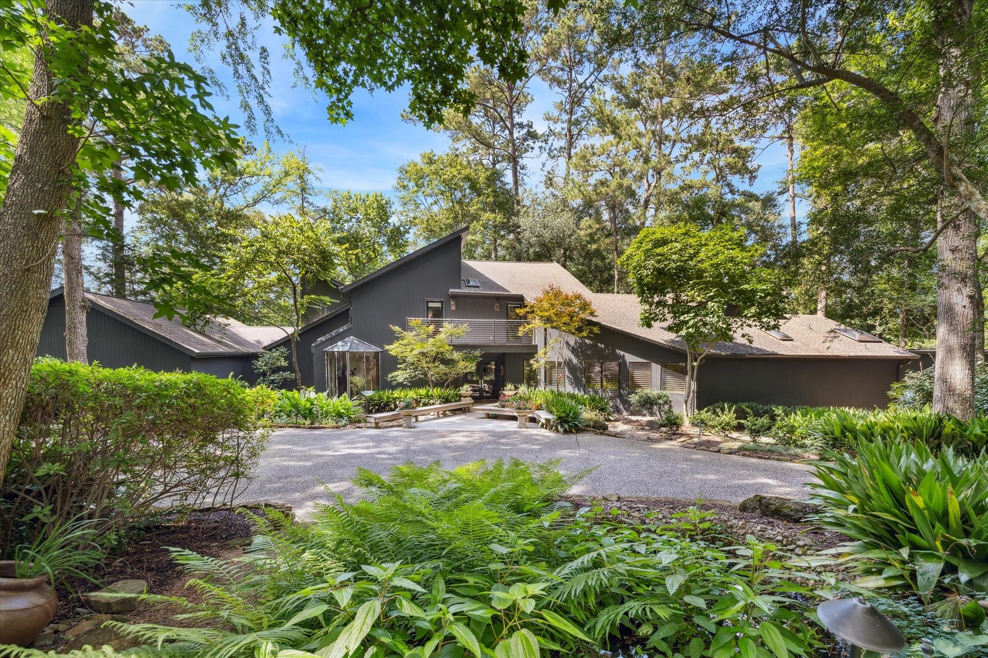 23414 Holly Hollow Street, Tomball, TX 77377 Nestled among mature trees, this striking contemporary home offers a private, park-like setting with exceptional curb appeal.