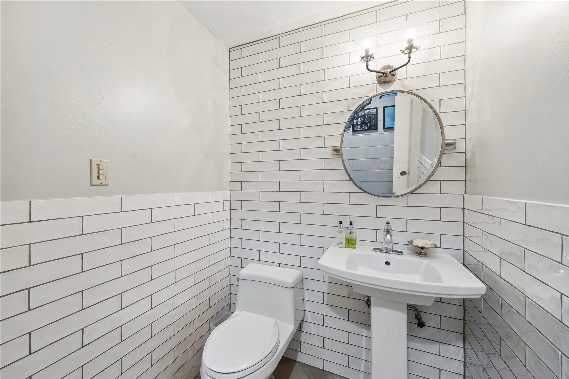 23414 Holly Hollow Street, Tomball, TX 77377 Half bath tucked into the lower level, offering a convenient and polished space for guests or family use.