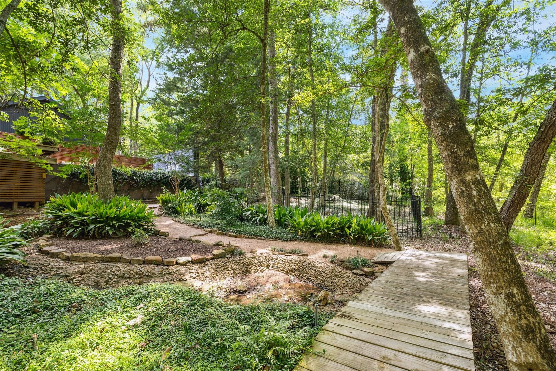 23414 Holly Hollow Street, Tomball, TX 77377 Surrounded by mature trees and greenery, reinforcing the homes retreat-like setting.