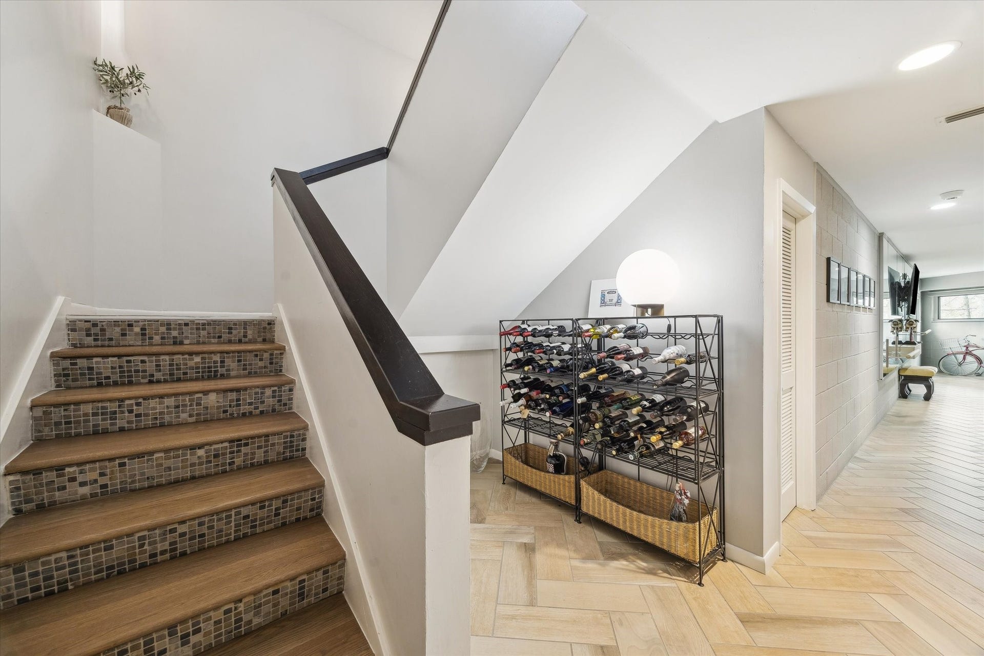 23414 Holly Hollow Street, Tomball, TX 77377 An architectural transition that feels as intentional as the rooms it connects. This is the lower level of the home which also offers a half bath, a flex space and an oversized utility room.