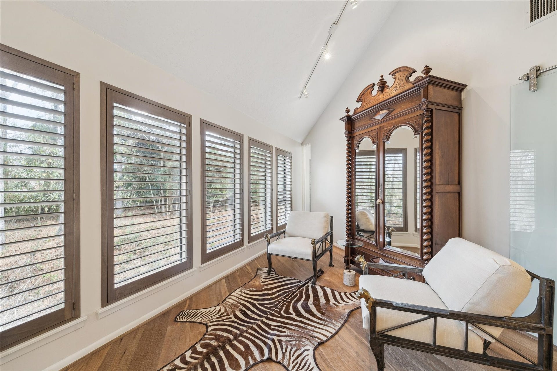 23414 Holly Hollow Street, Tomball, TX 77377 Charming seating nook within the primary bedroom, perfectly positioned to overlook the wooded backyard and create a serene refuge for morning coffee or evening relaxation.